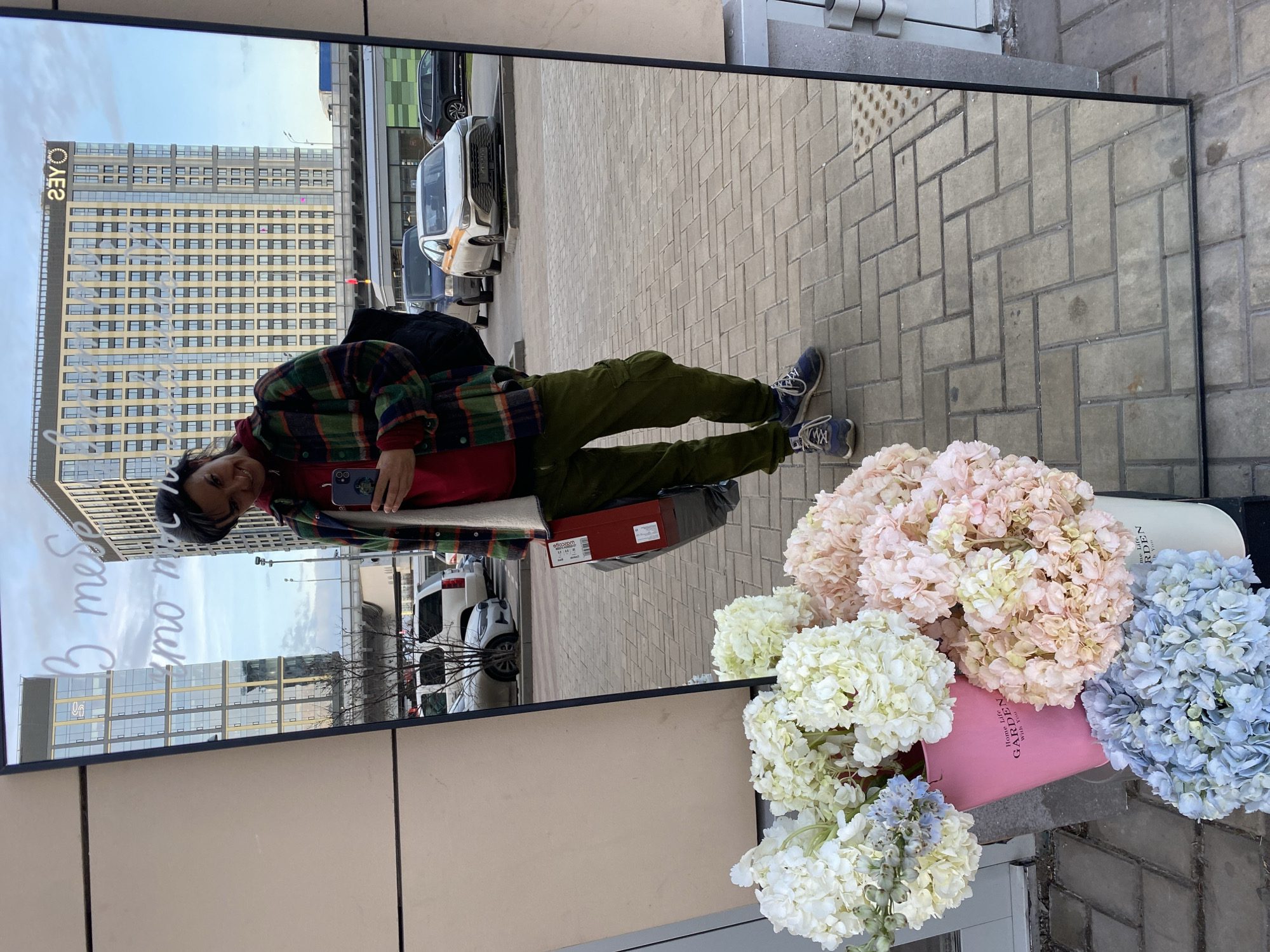 Person takes phone photo reflected in mirror on Moscow sidewalk