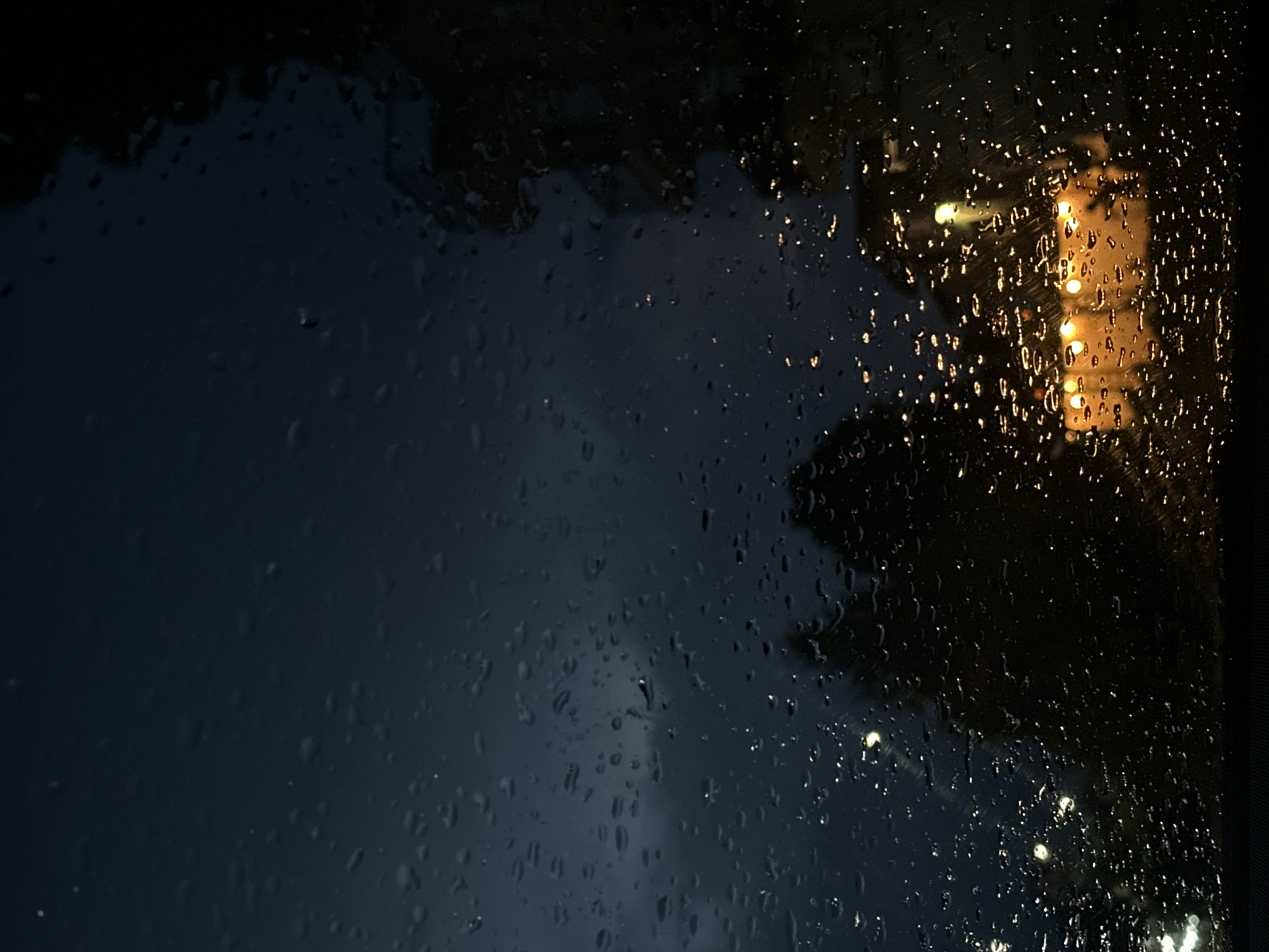 Rainy night documented through windows in Byala, Bulgaria