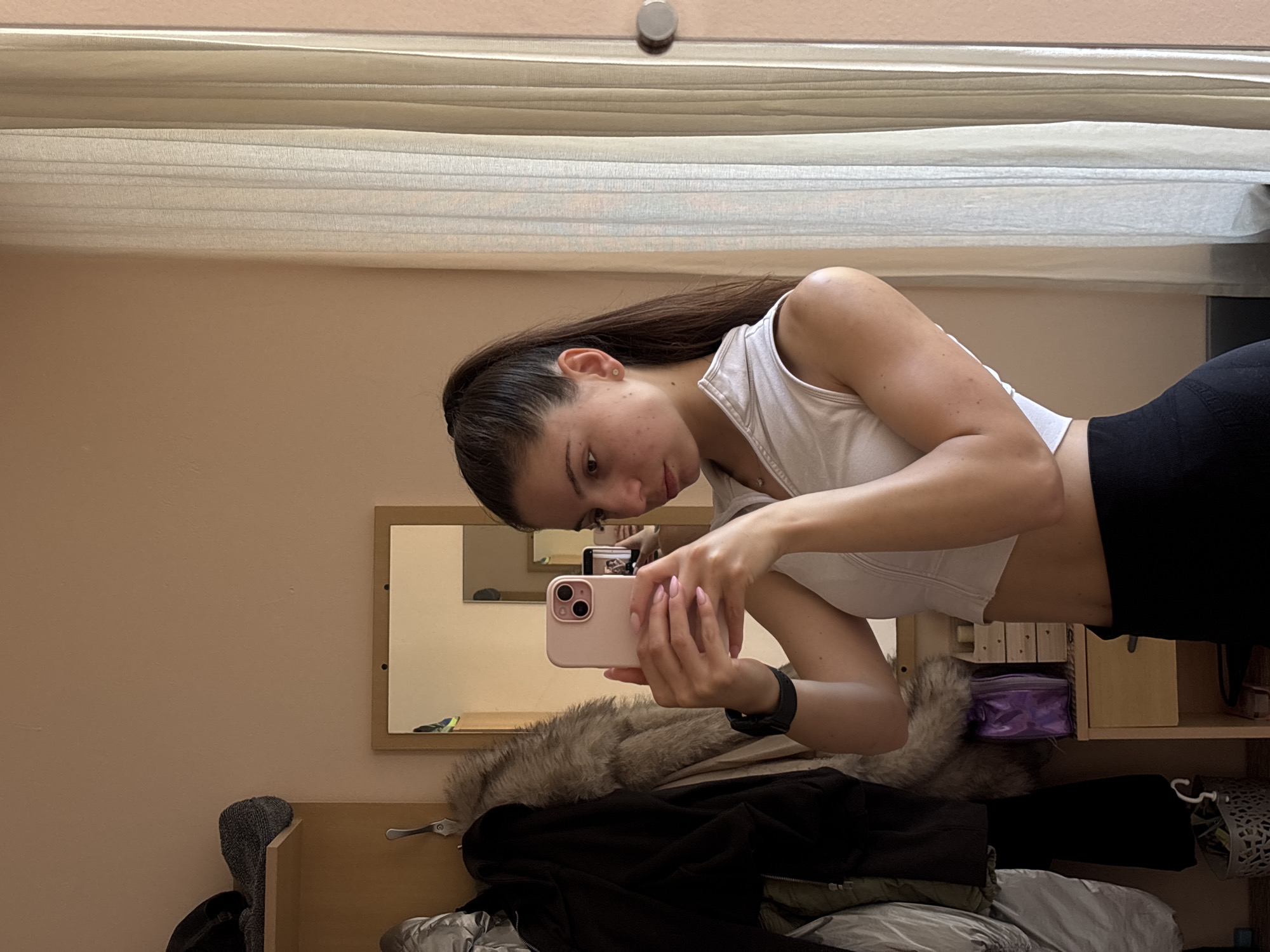 Young woman takes mirror selfies in Varna residential room