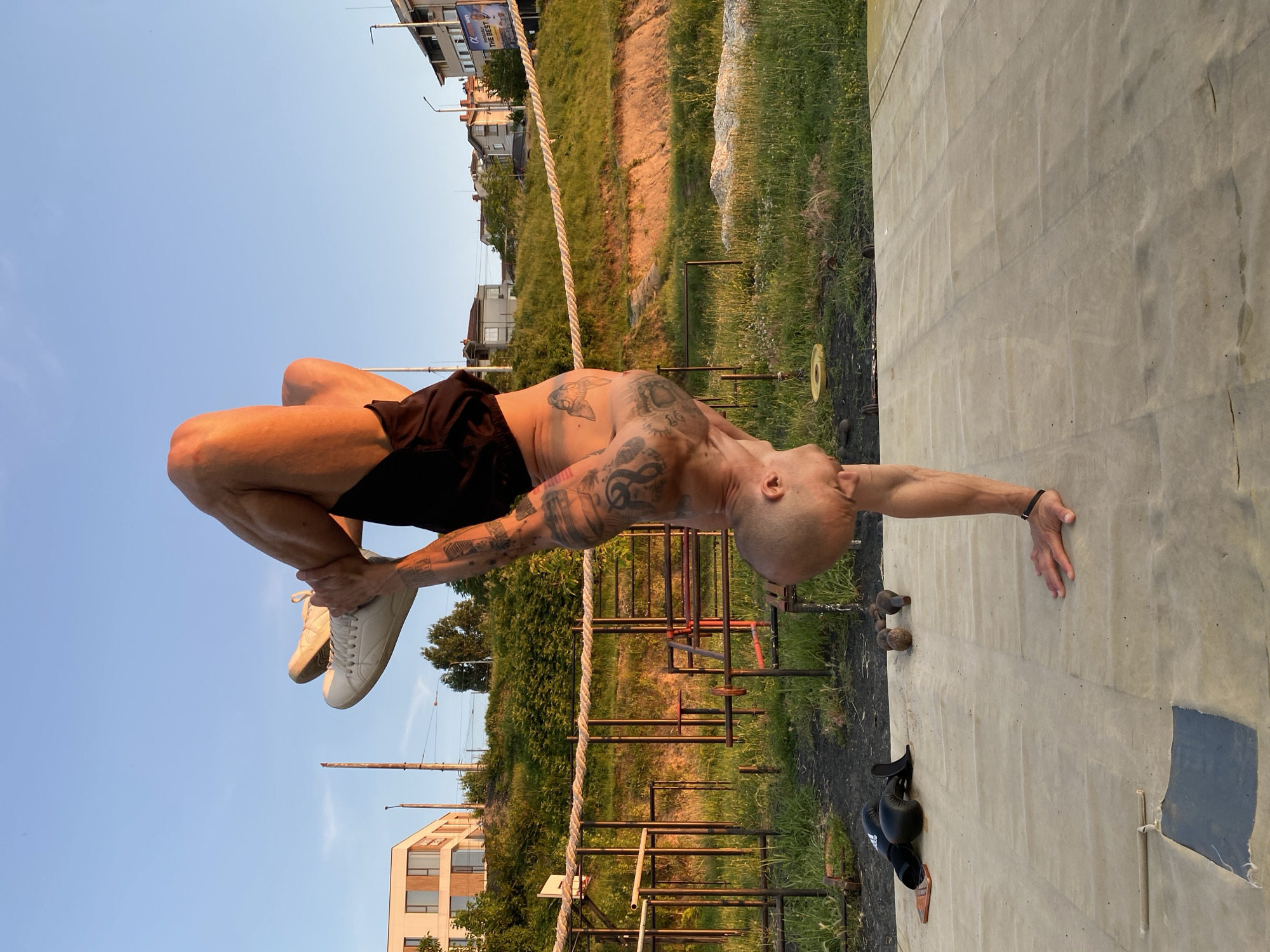 Tattooed athlete trains boxing and handstands in Pleven