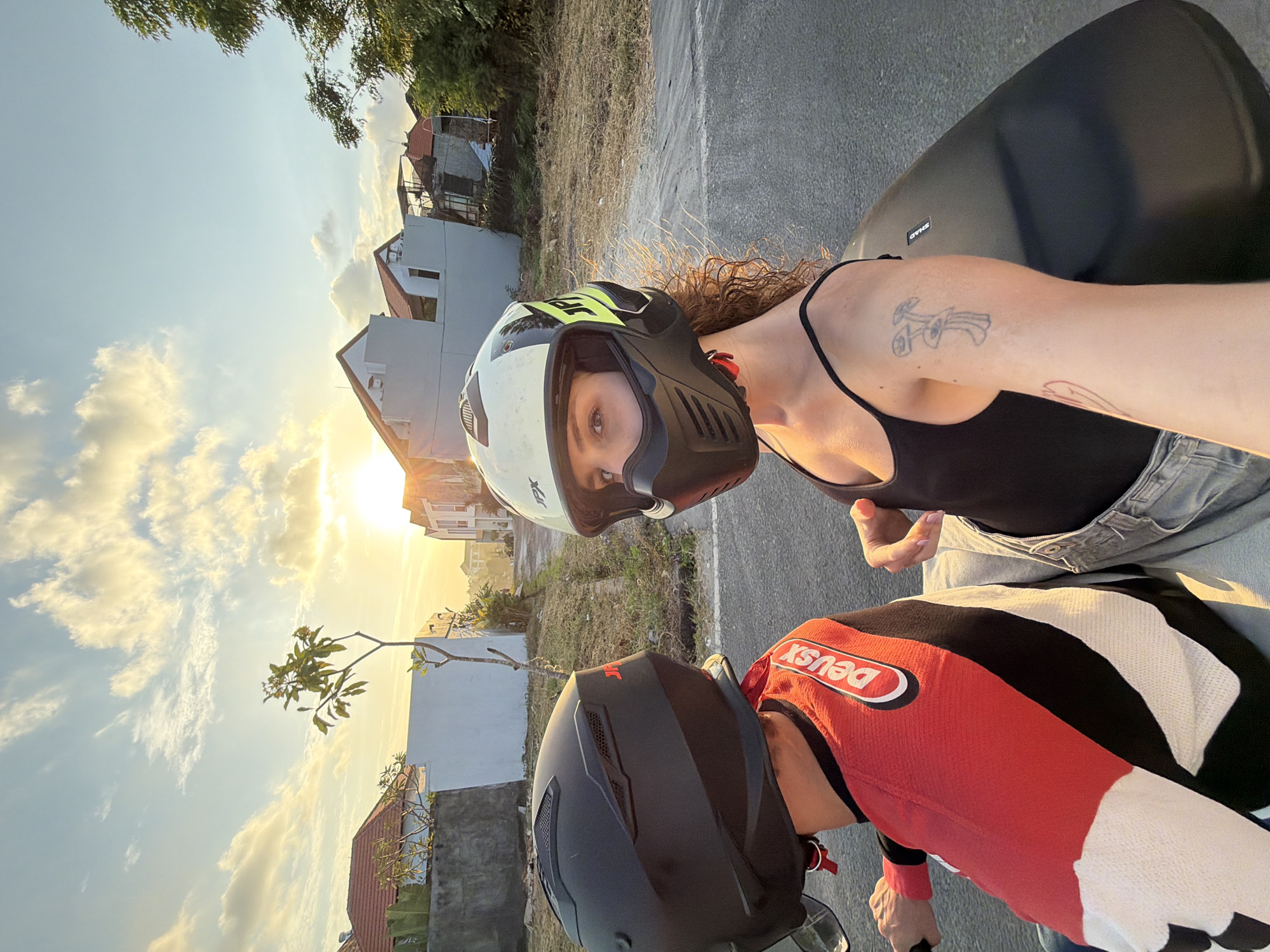 Motorcycle passengers take selfies during North Kuta ride