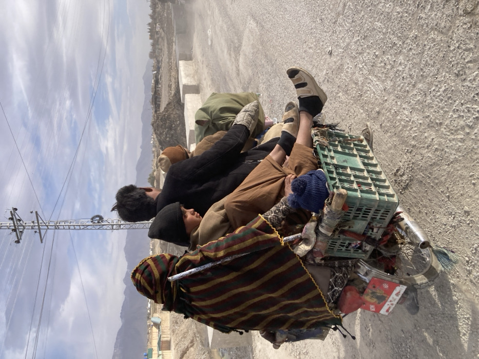 Five people ride overloaded motorcycle on dusty Quetta road