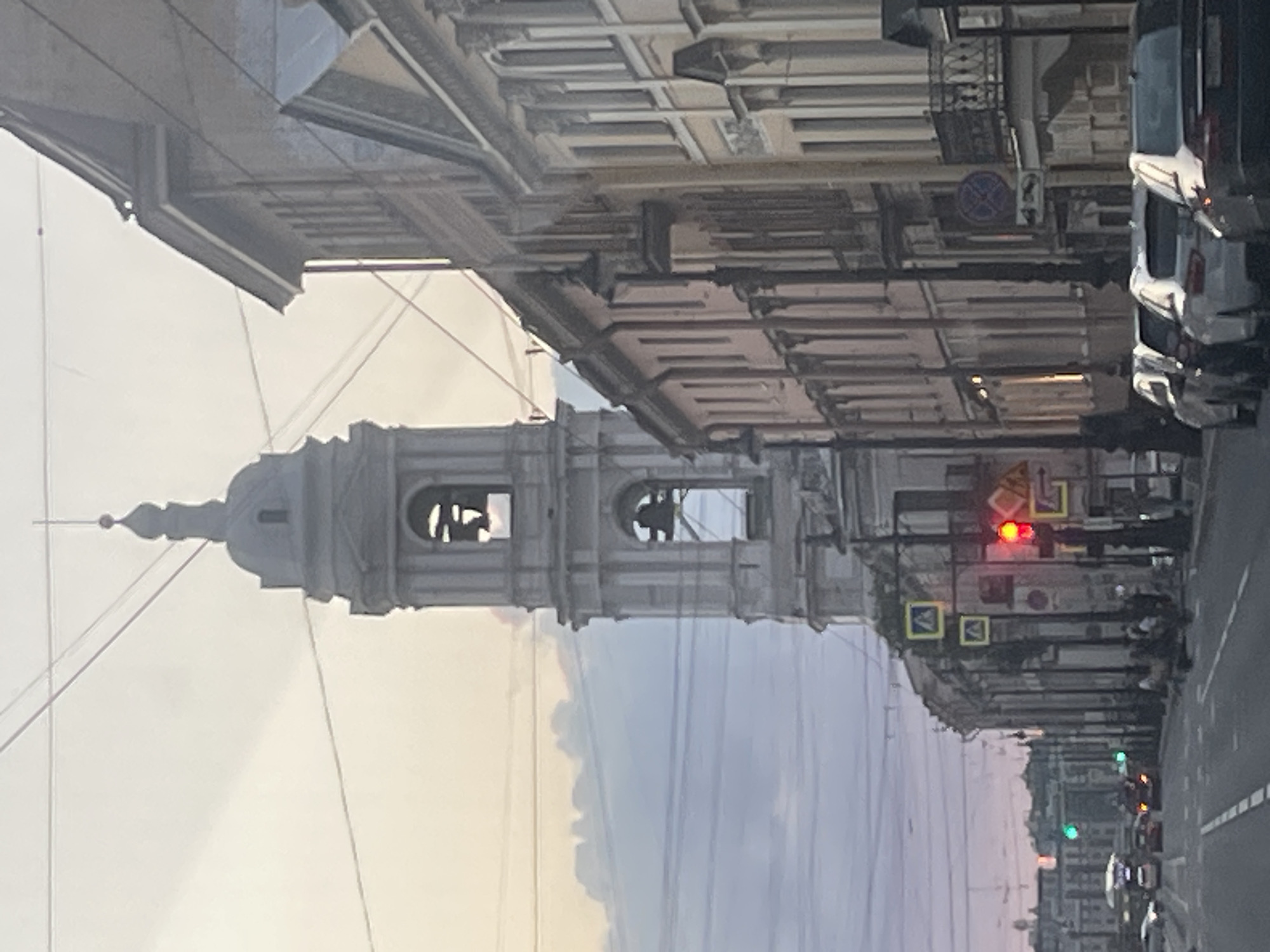 Saint Petersburg street scene with a white bell tower at dusk