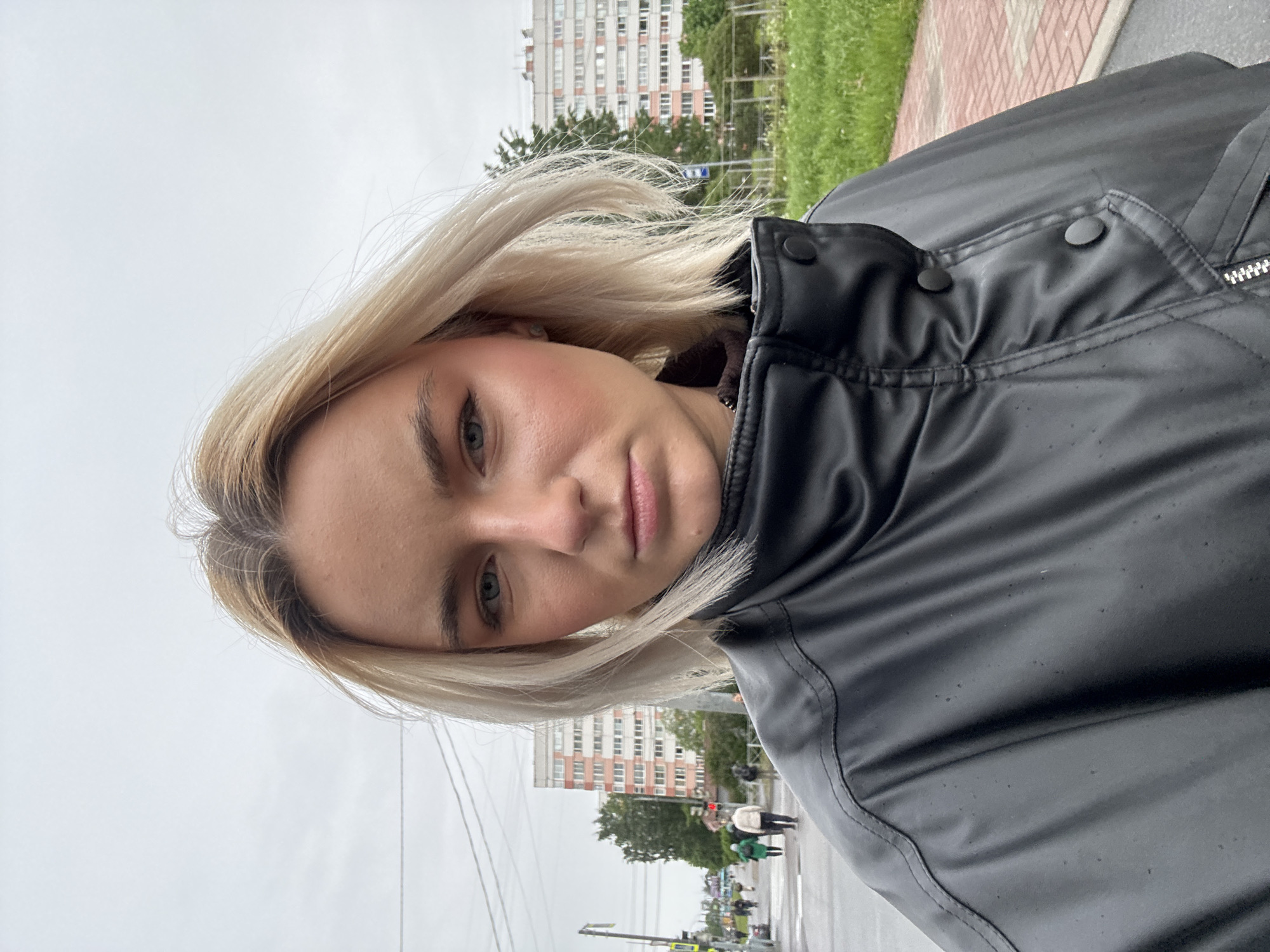 Young blonde woman in black jacket photographed in Russia
