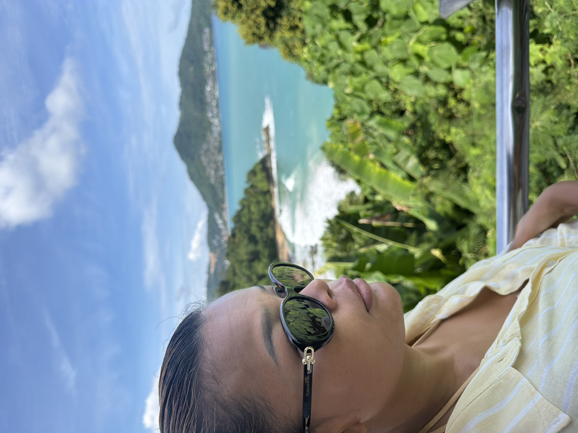 Woman photographed at Thai bay amid tropical landscape documentation