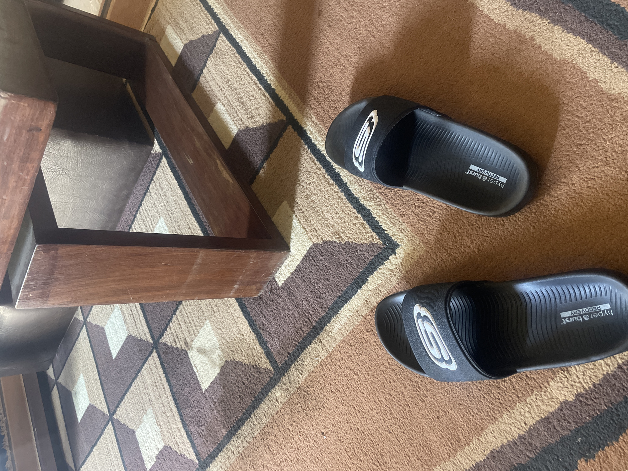 Indoor scene captured in Gura Top showing stool and sandals