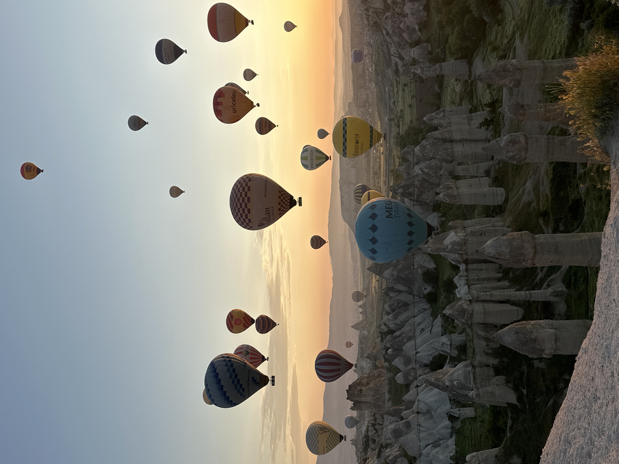 Hot air balloons fill sunrise sky over Cappadocia