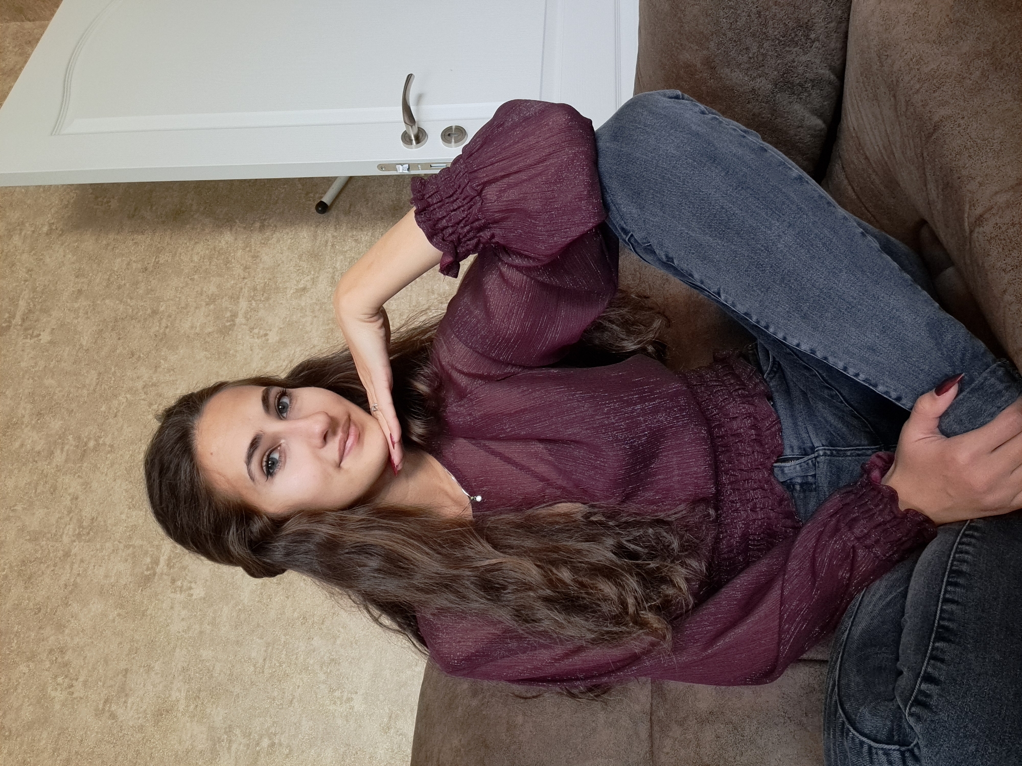 Woman poses for photos on couch in Negovan