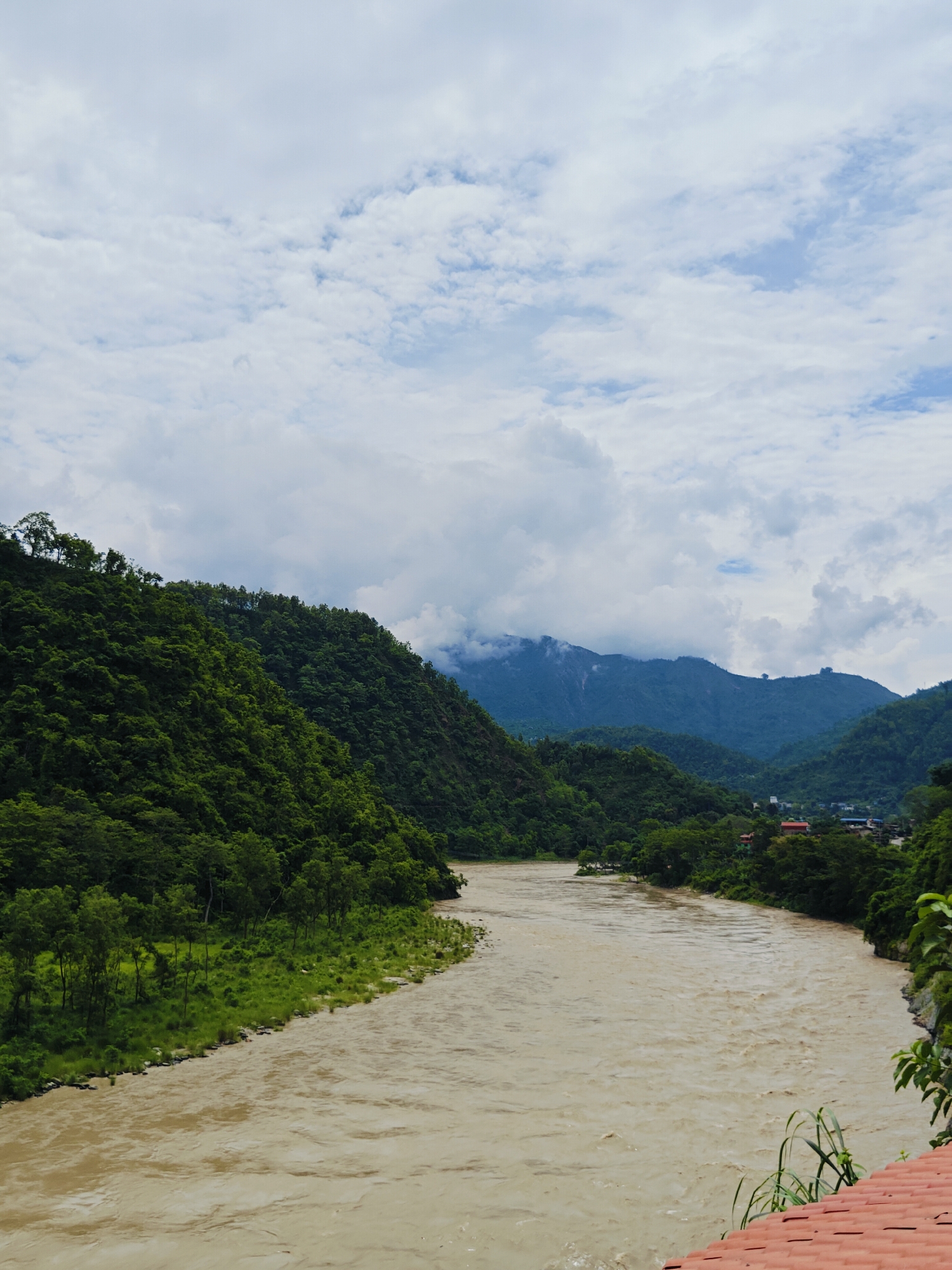 Poolside resort along a muddy river in Nepal's forested hills