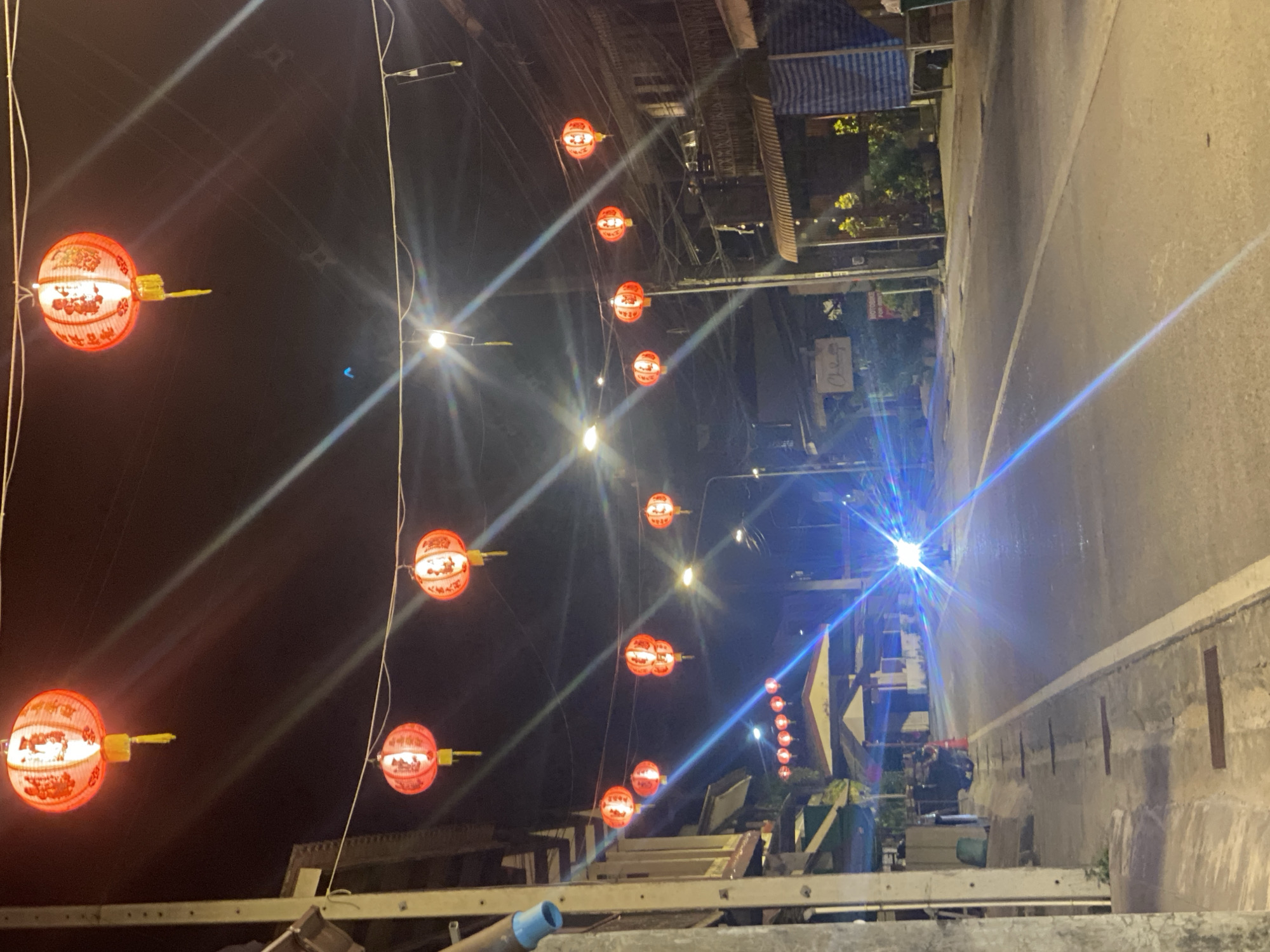 Nighttime street lights illuminate Baan Tai Thailand commercial district