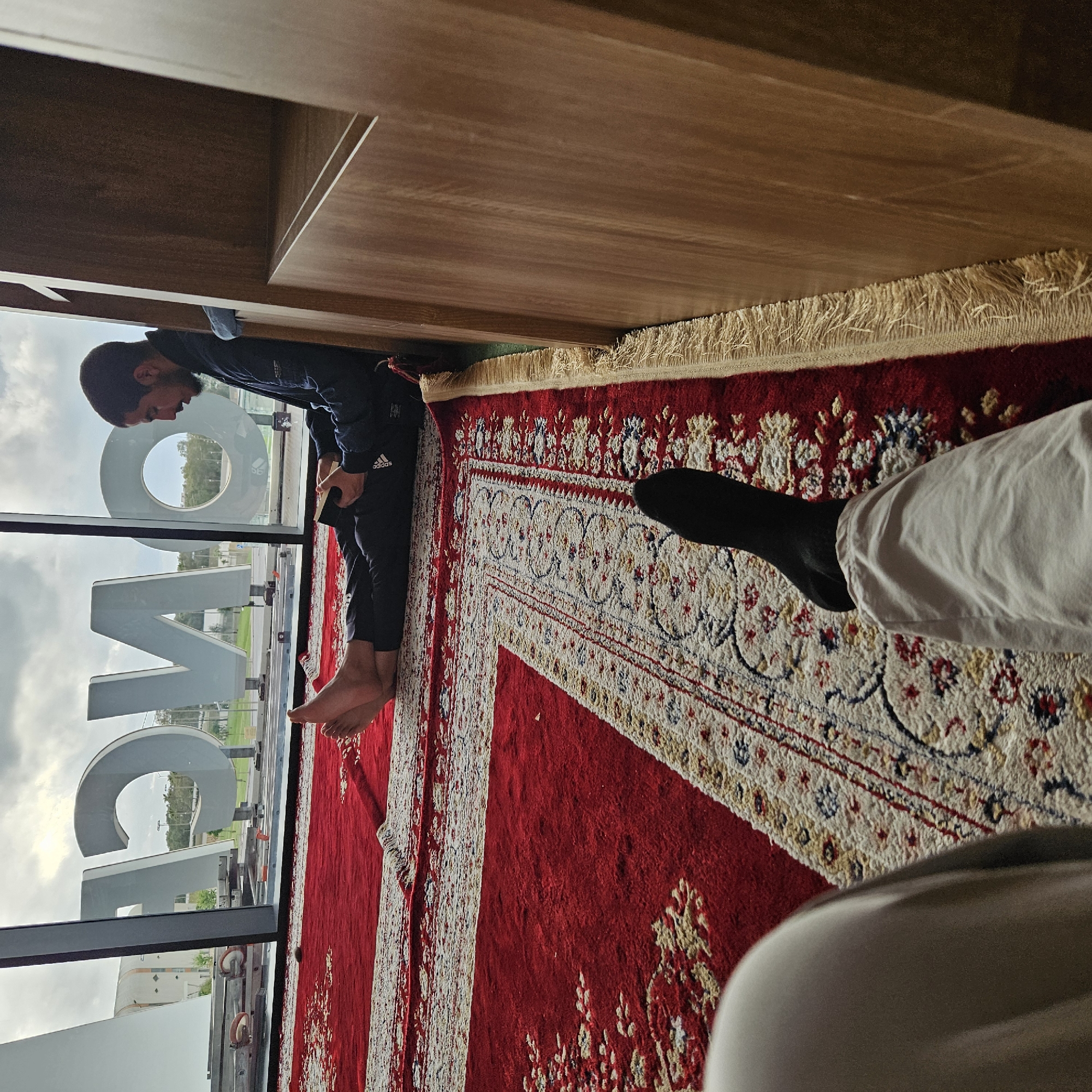 Evening indoor moments captured in Rabat residence with prayer rugs