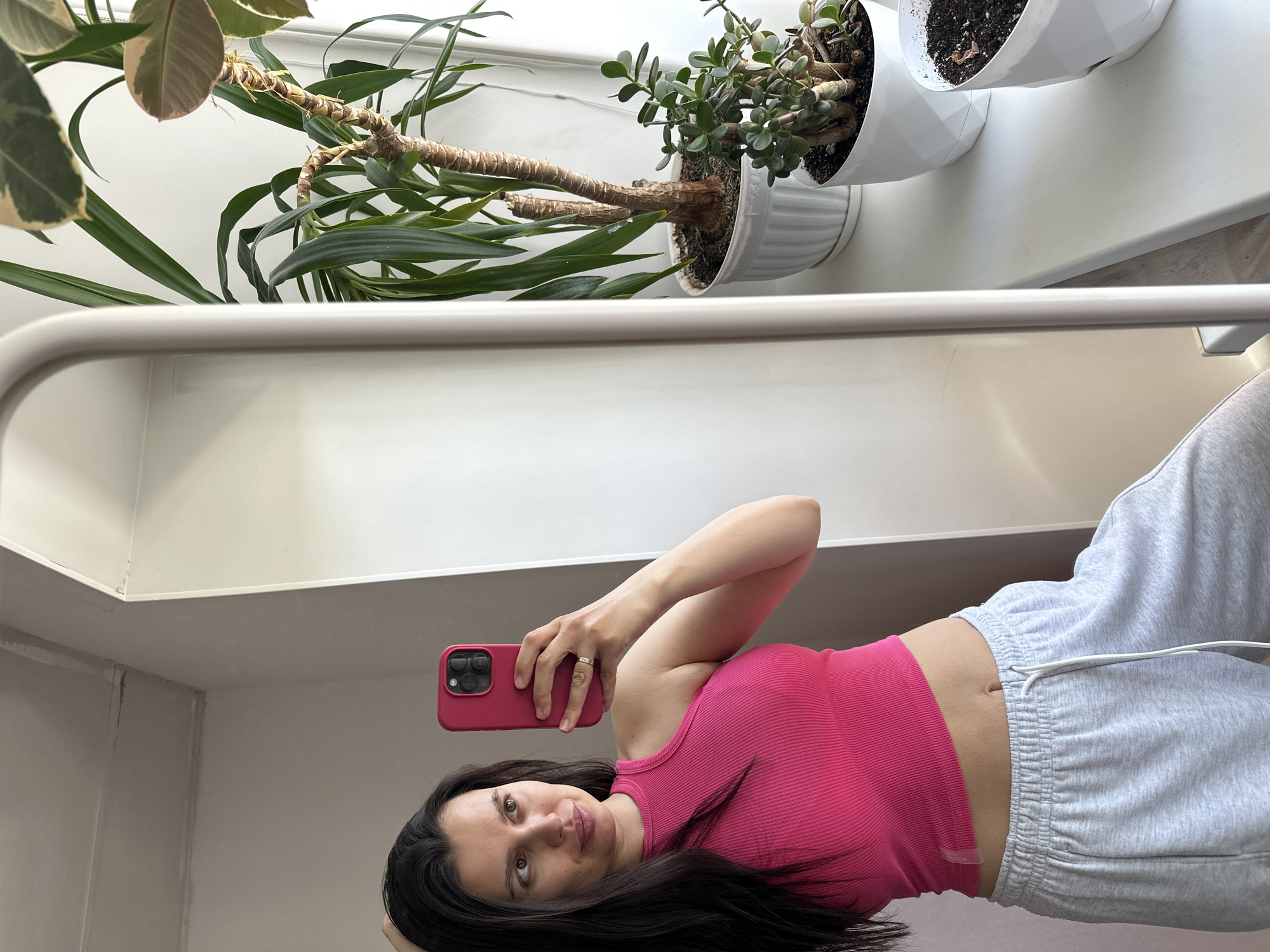 Woman takes morning selfies in pink top, Chaikovsky