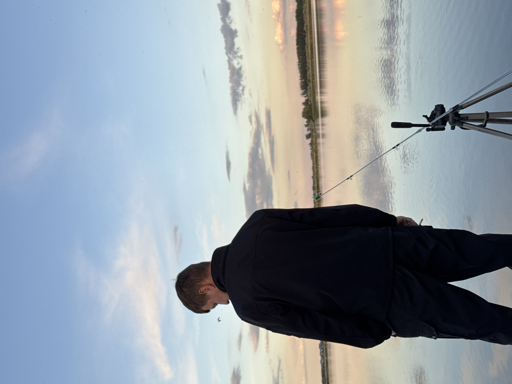 Angler enjoys peaceful fishing session on lake dock