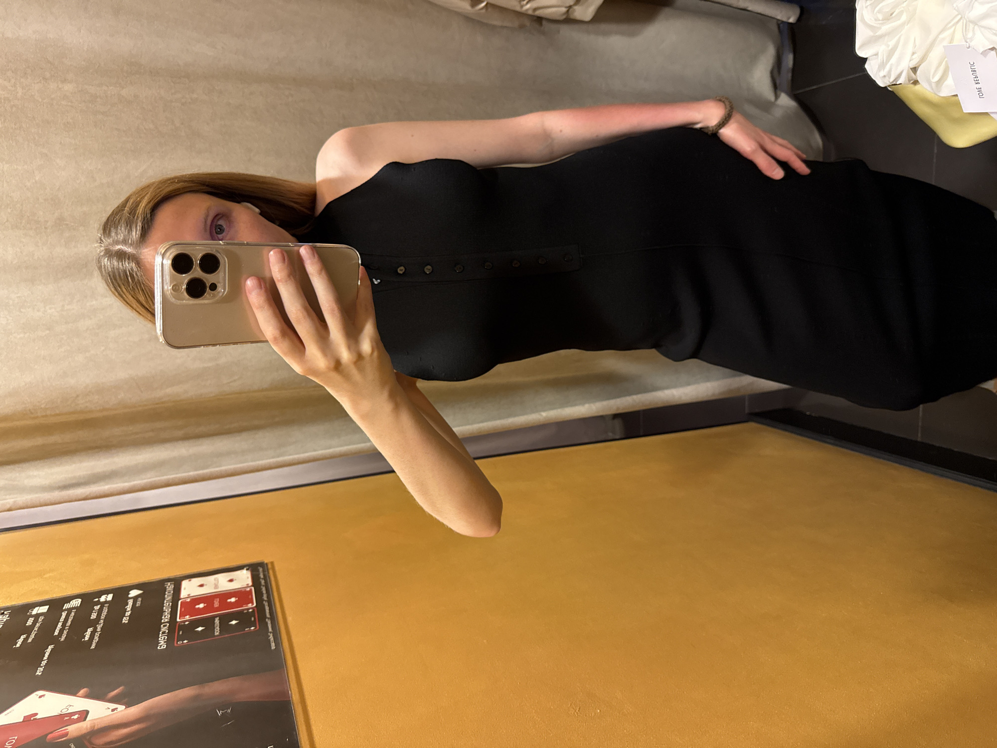 Fitting room try-on session, multiple outfits, midday.