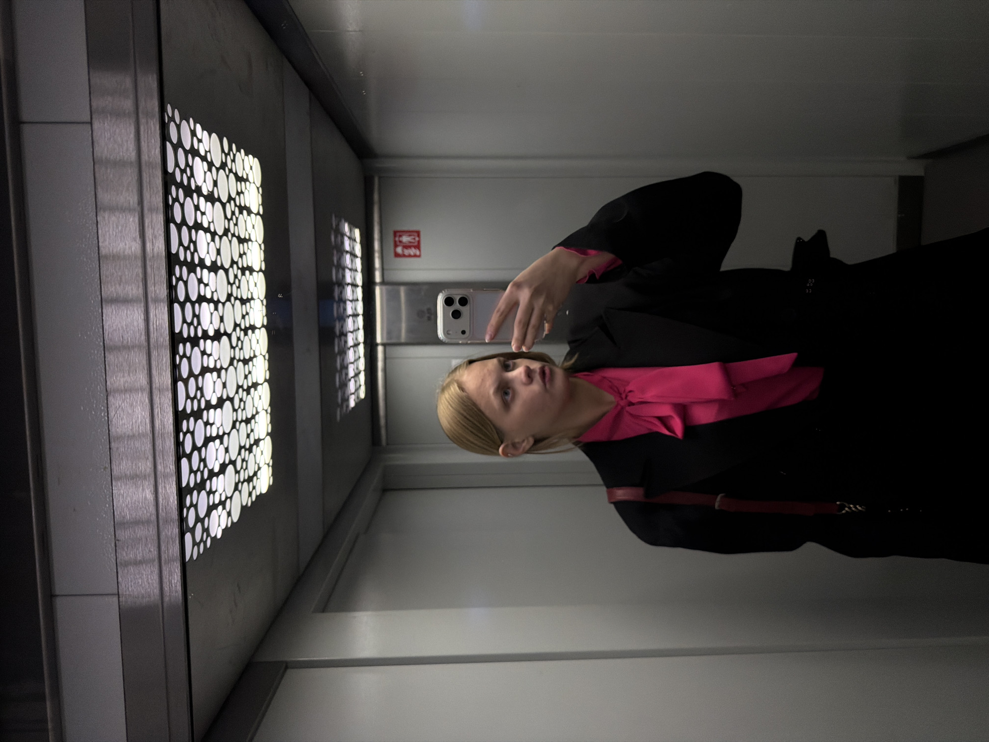 Woman takes multiple selfies across indoor locations in Izhevsk