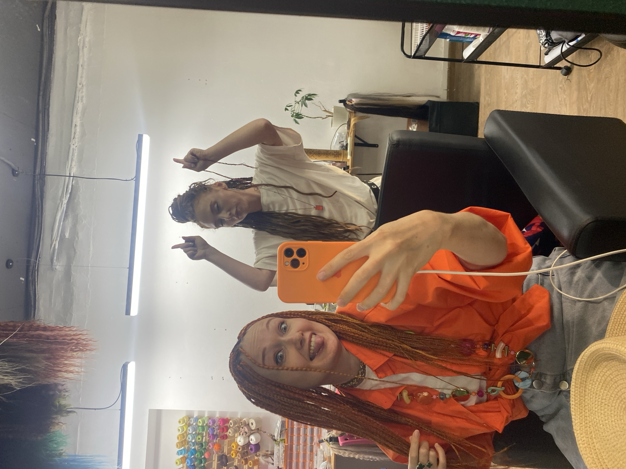 Woman captures salon selfie with orange braids in Sochi