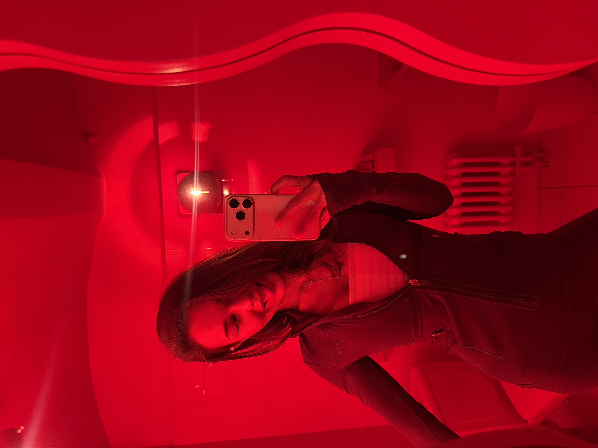 Woman photographs herself and Moscow architecture during evening session