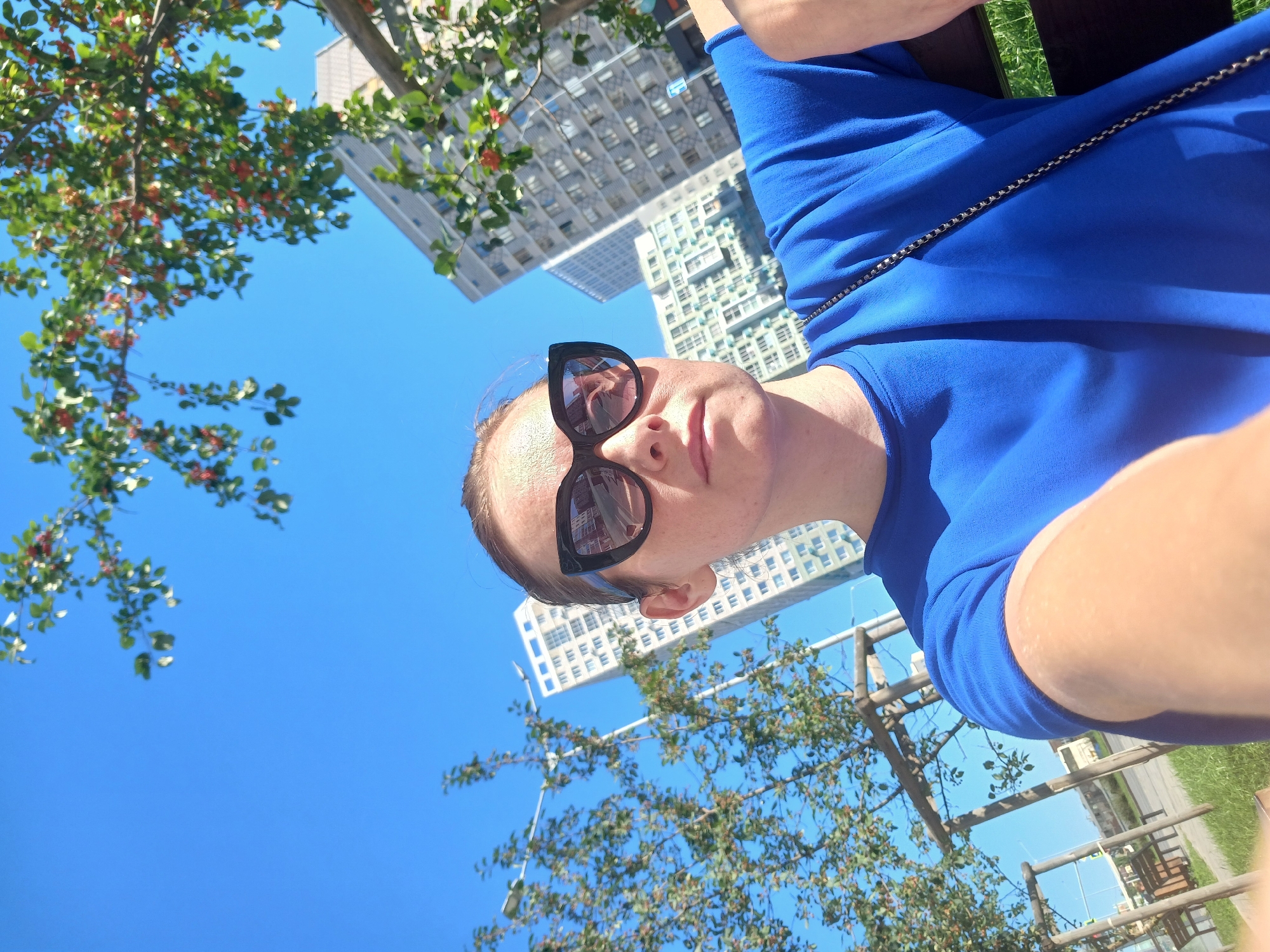 Sunny selfie session near Yekaterinburg apartments, blue outfit