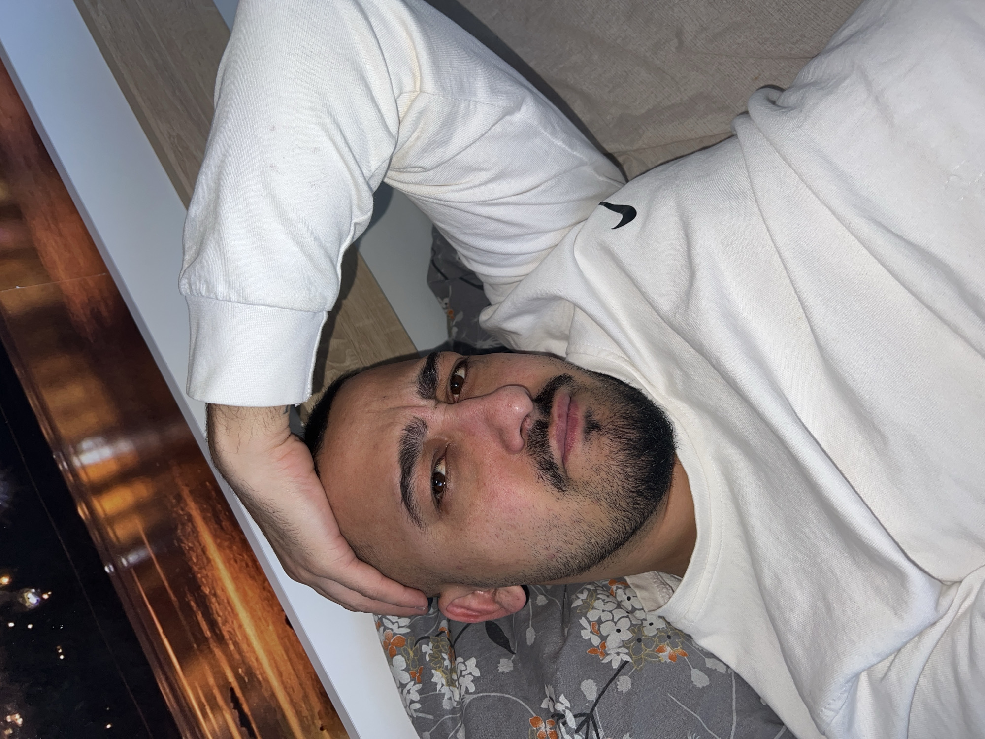 Man rests on bed in Shumata, Bulgaria