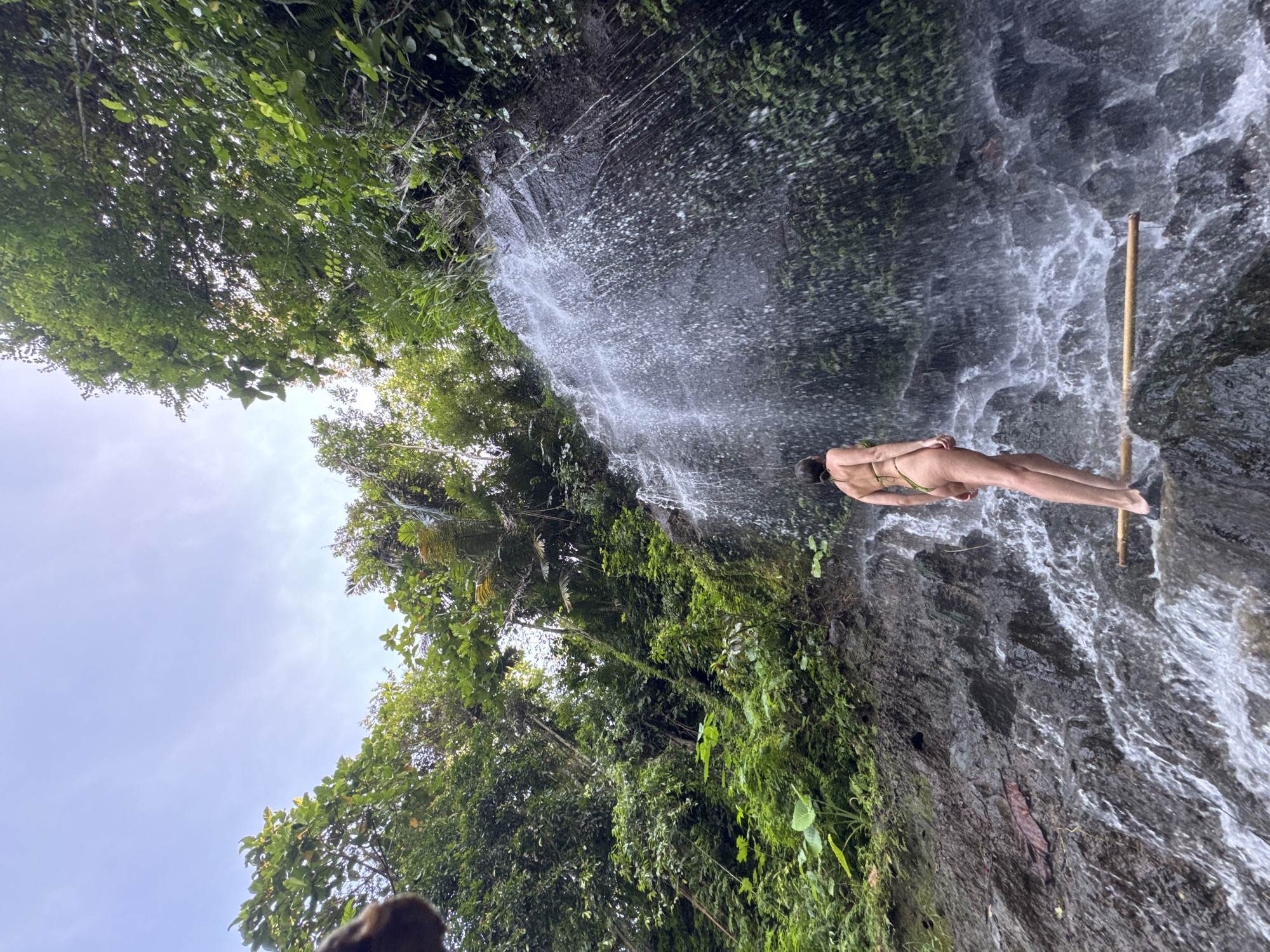 Tourist visits waterfall site in rural Gianyar, Indonesia