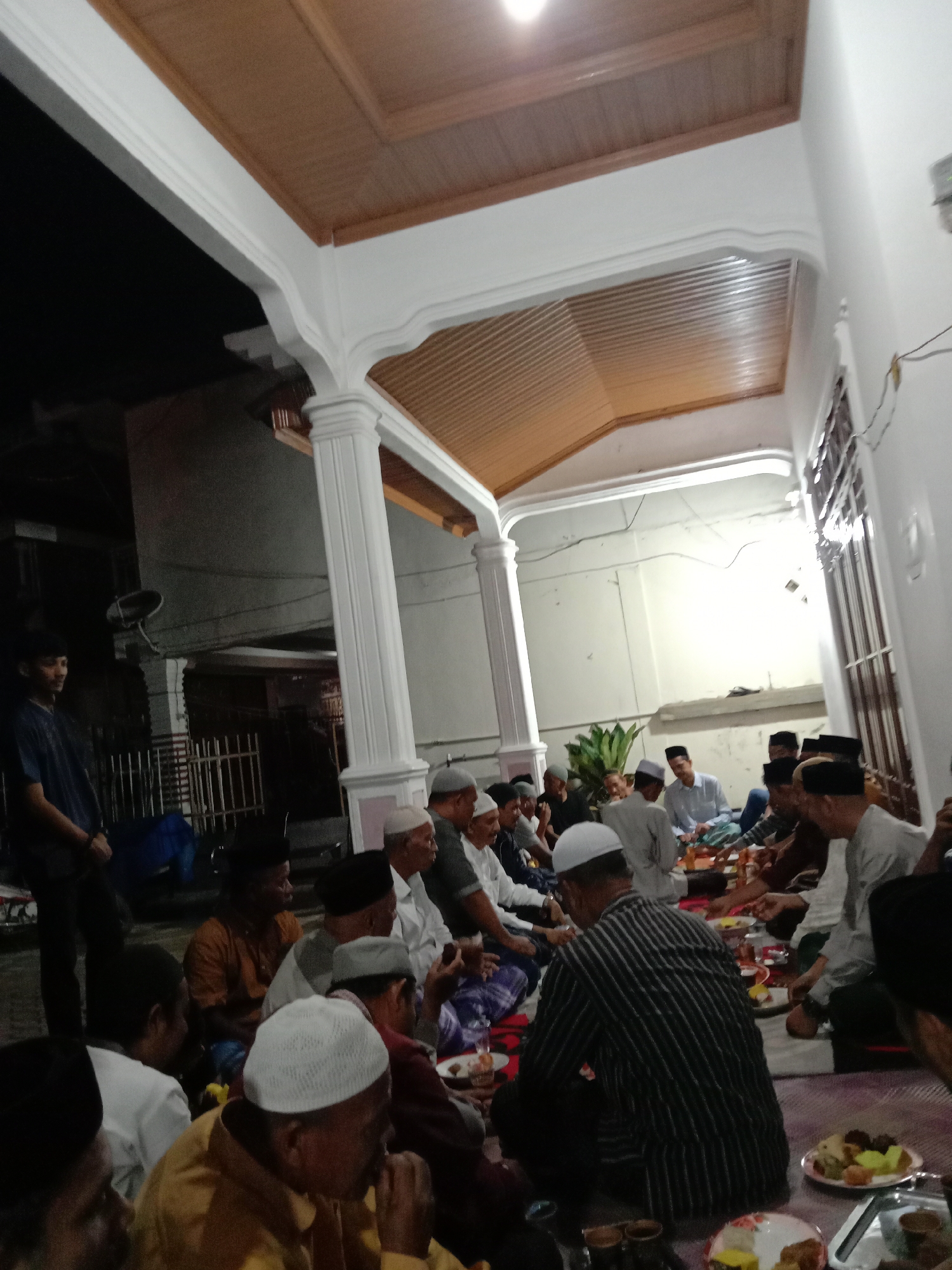 Men gather for communal meal in Lhokseumawe, Indonesia