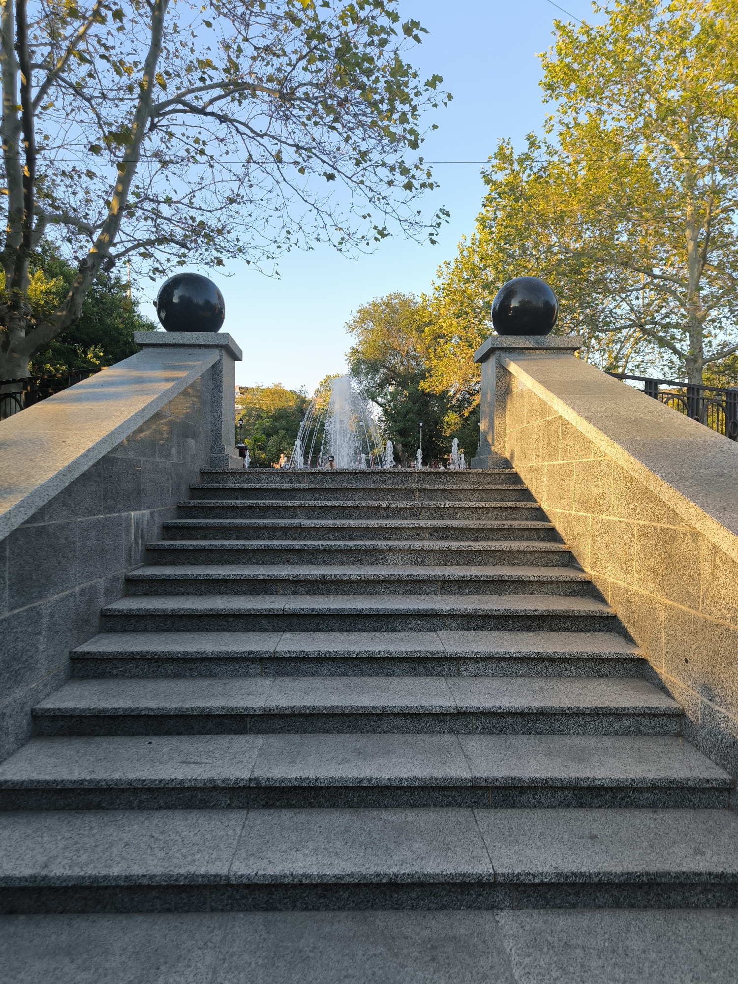 Mykolaiv park at golden hour — fountains, paths, and late summer light
