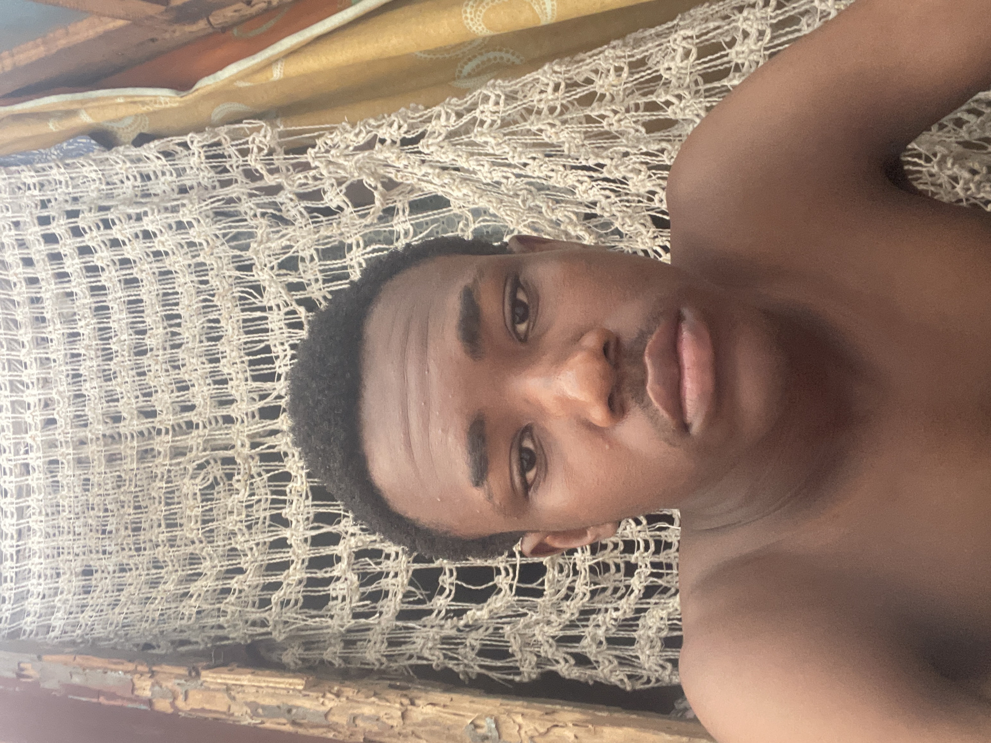 Man rests indoors during afternoon in Lagos residential area