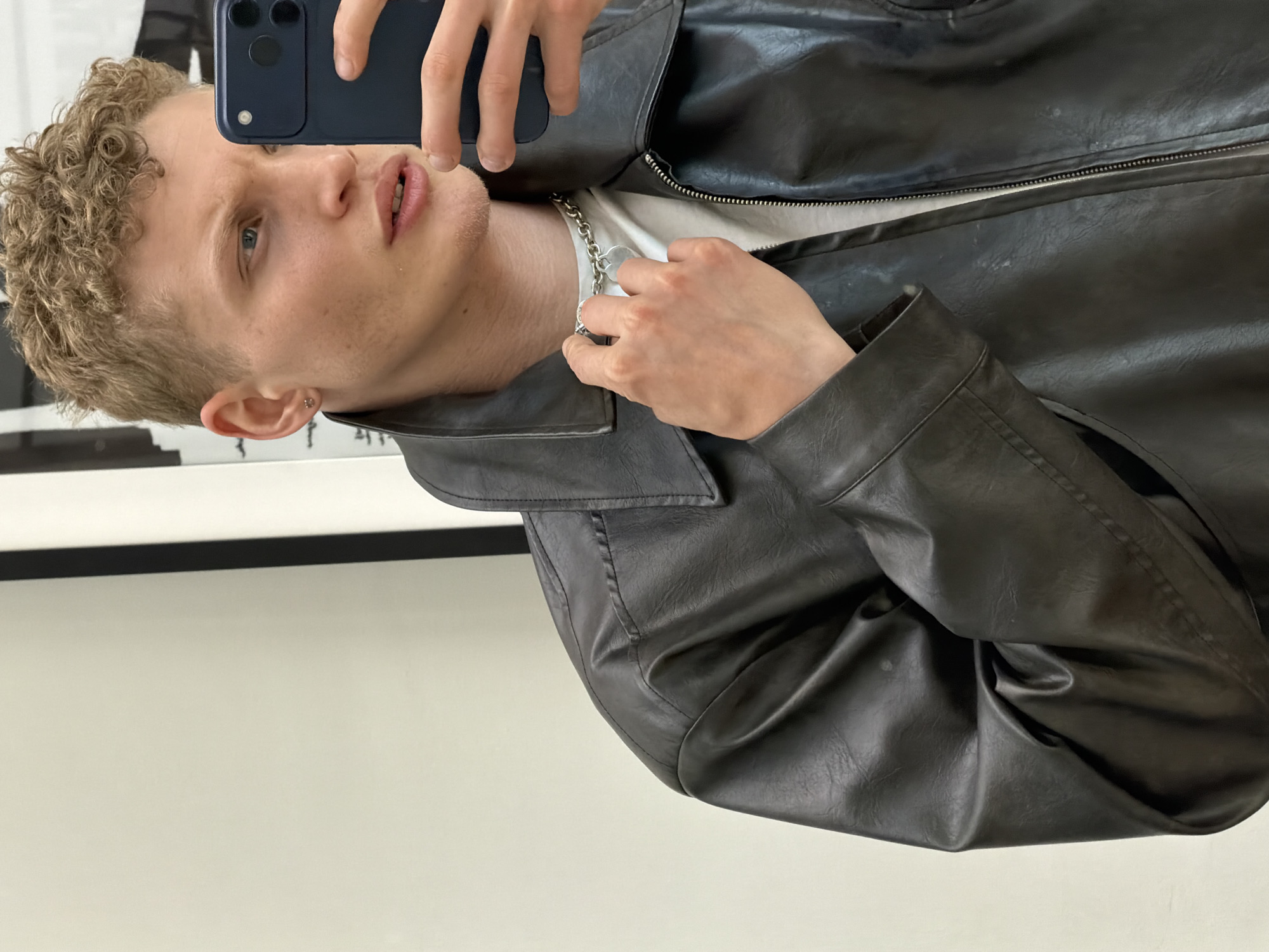 Young man takes selfies indoors in London