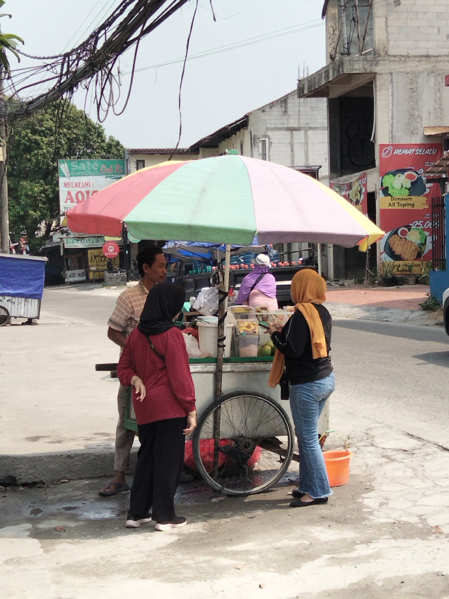 Morning street life and commerce in Depok, Indonesia