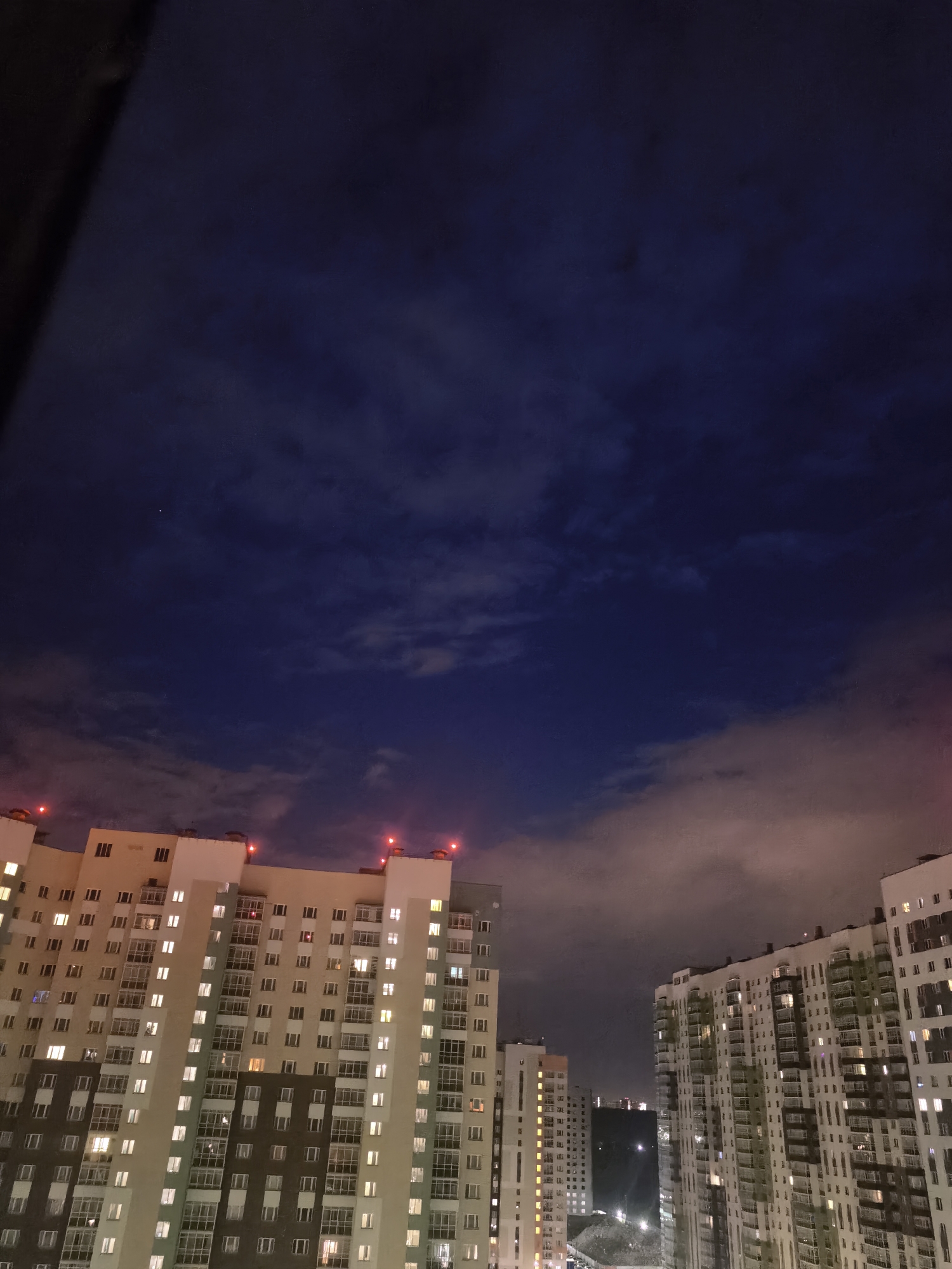 Dusk aerial views of a residential complex and rocket launch