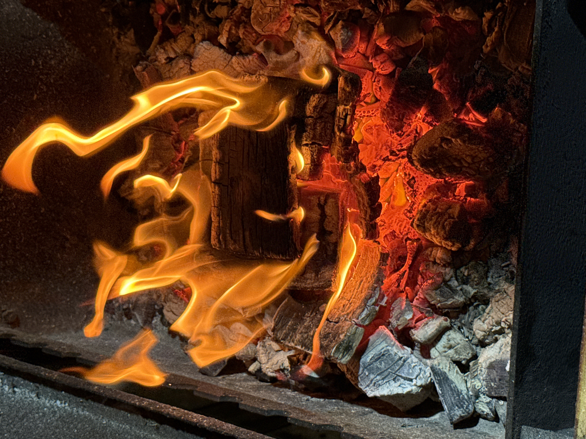 Bacon-wrapped bites prepped over a live charcoal grill in Kamyshin