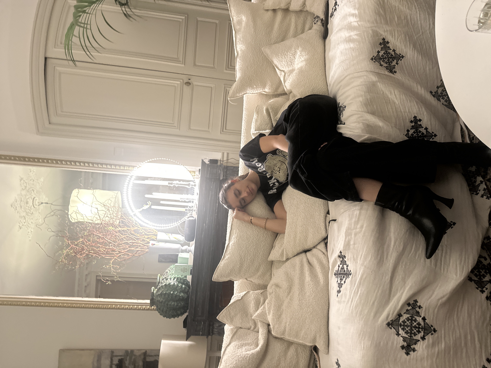 Woman rests on sofa in Paris interior setting