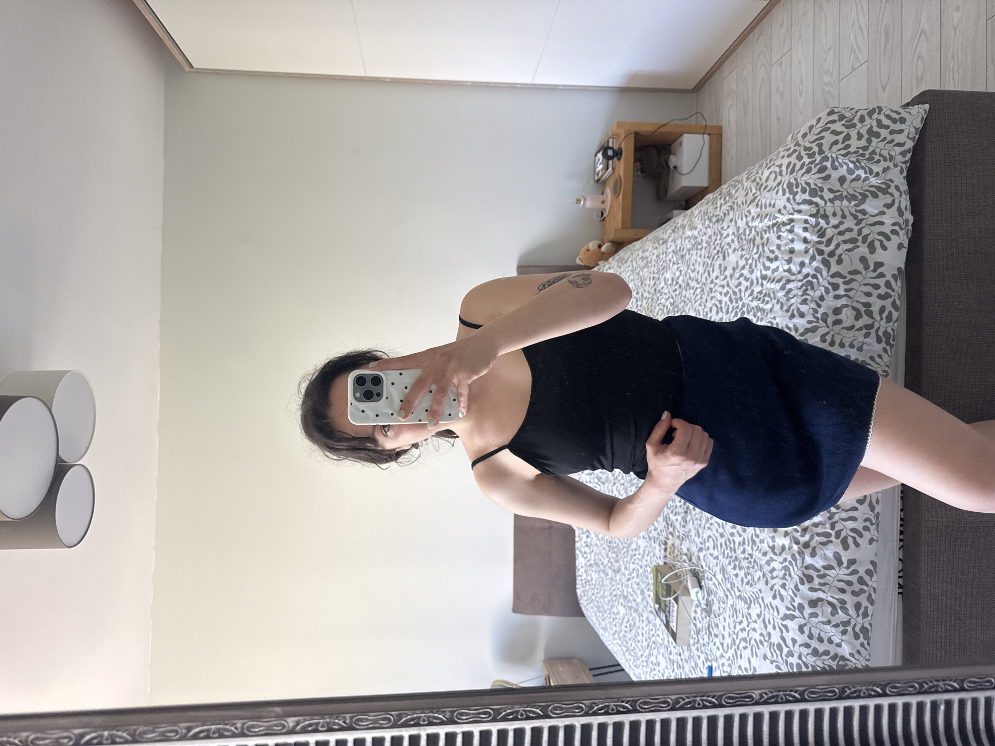 Woman takes mirror selfie in bedroom in Burgas, Bulgaria