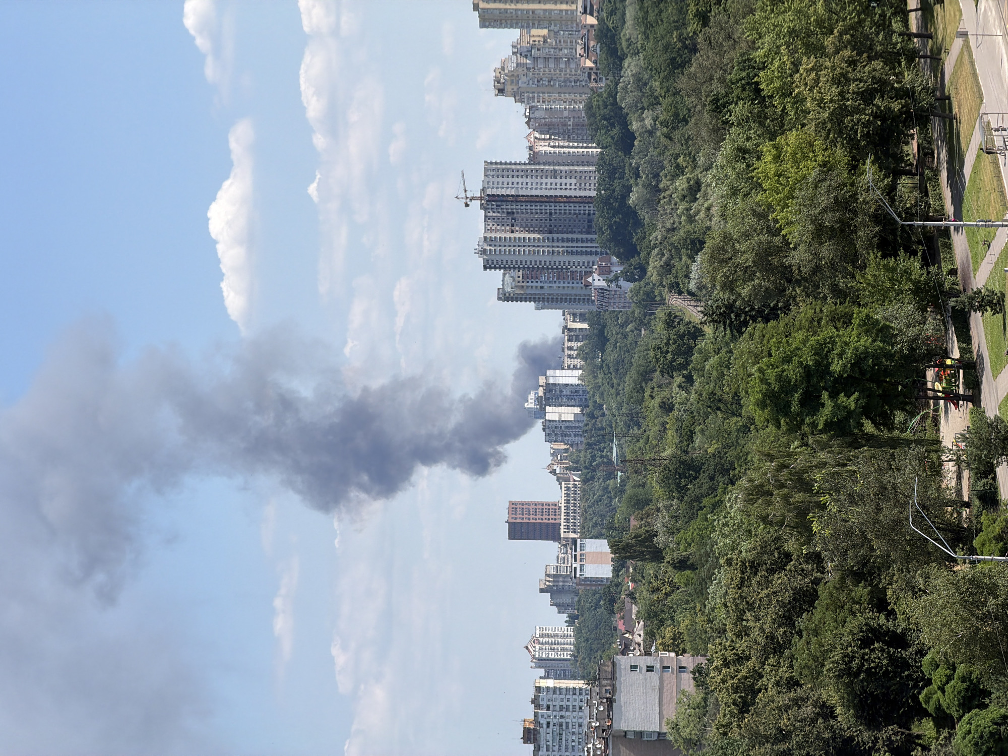 Dark smoke rises over Kyiv skyline on a clear morning