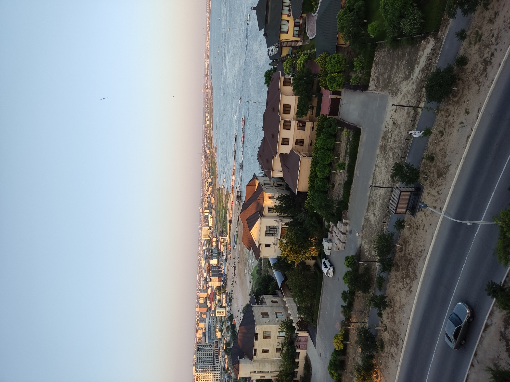 Aerial pass over coastal buildings and waterfront property