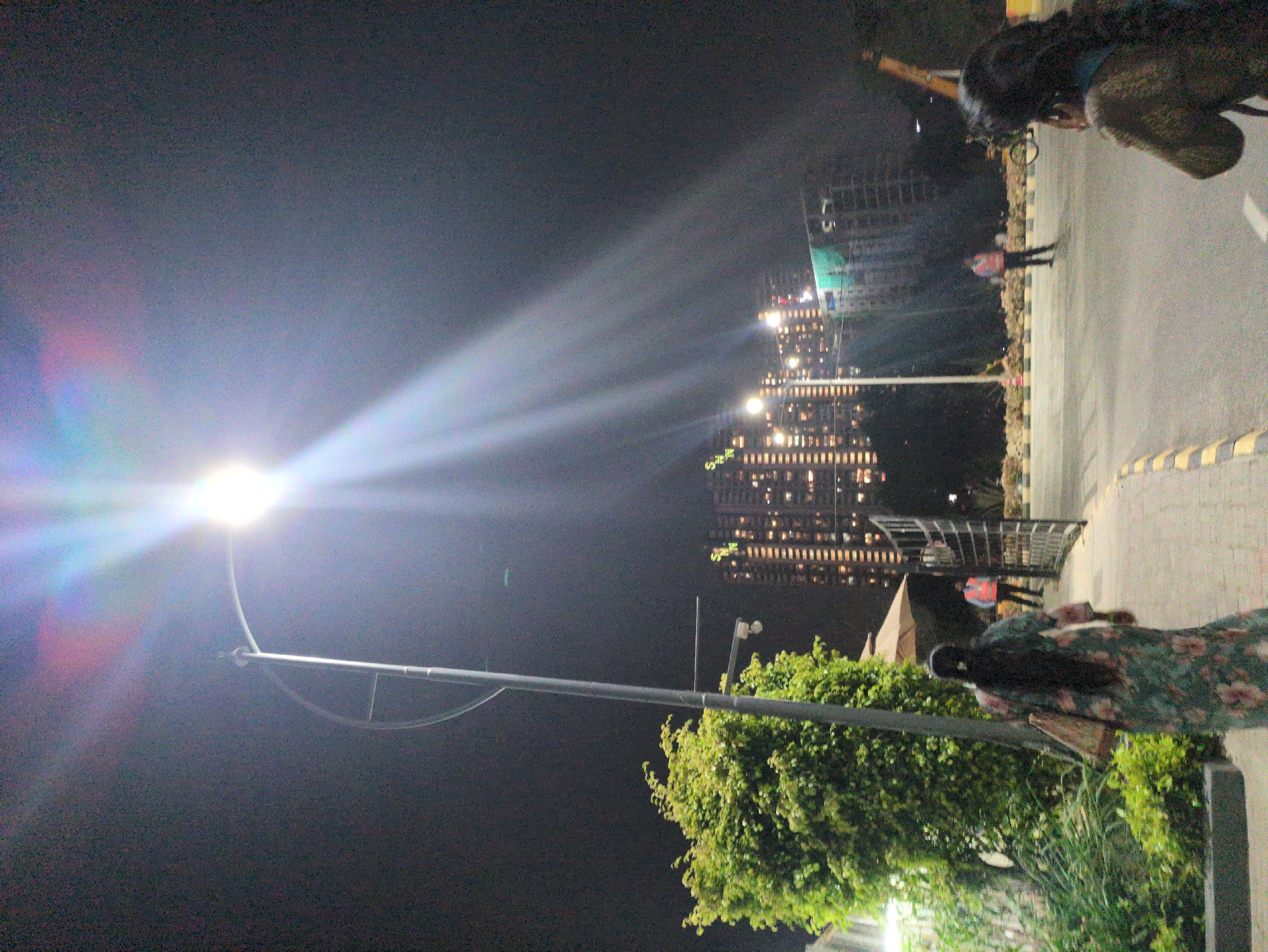 Evening pedestrian activity observed on illuminated Bengaluru streets