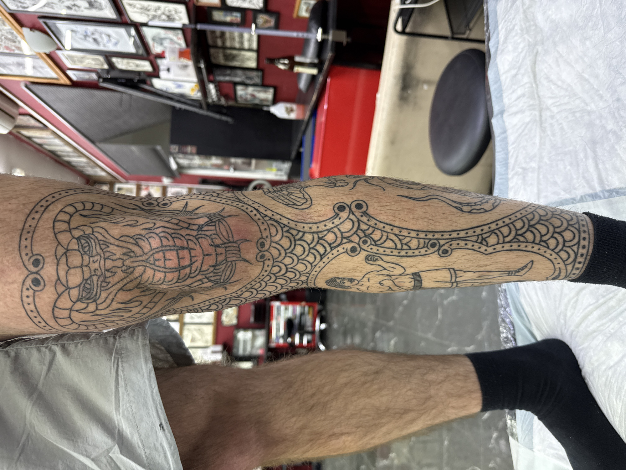 Person displays intricate leg tattoo work in Moscow studio