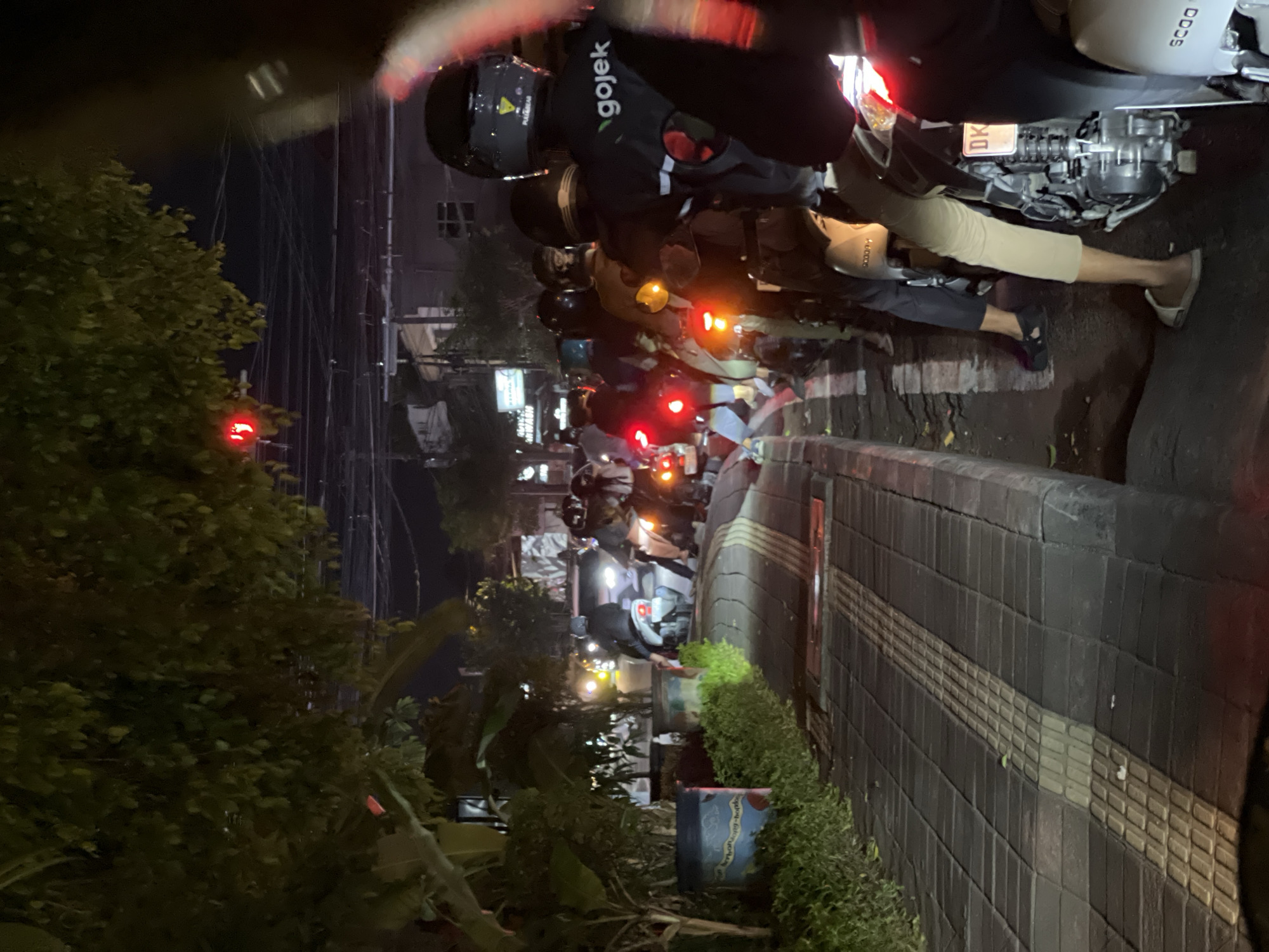 Motorcycle traffic backed up at a Denpasar intersection at night