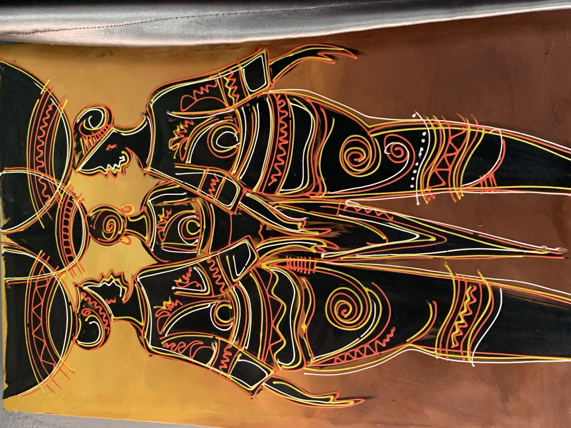 Abstract art piece with three stylized figures observed in Nigeria