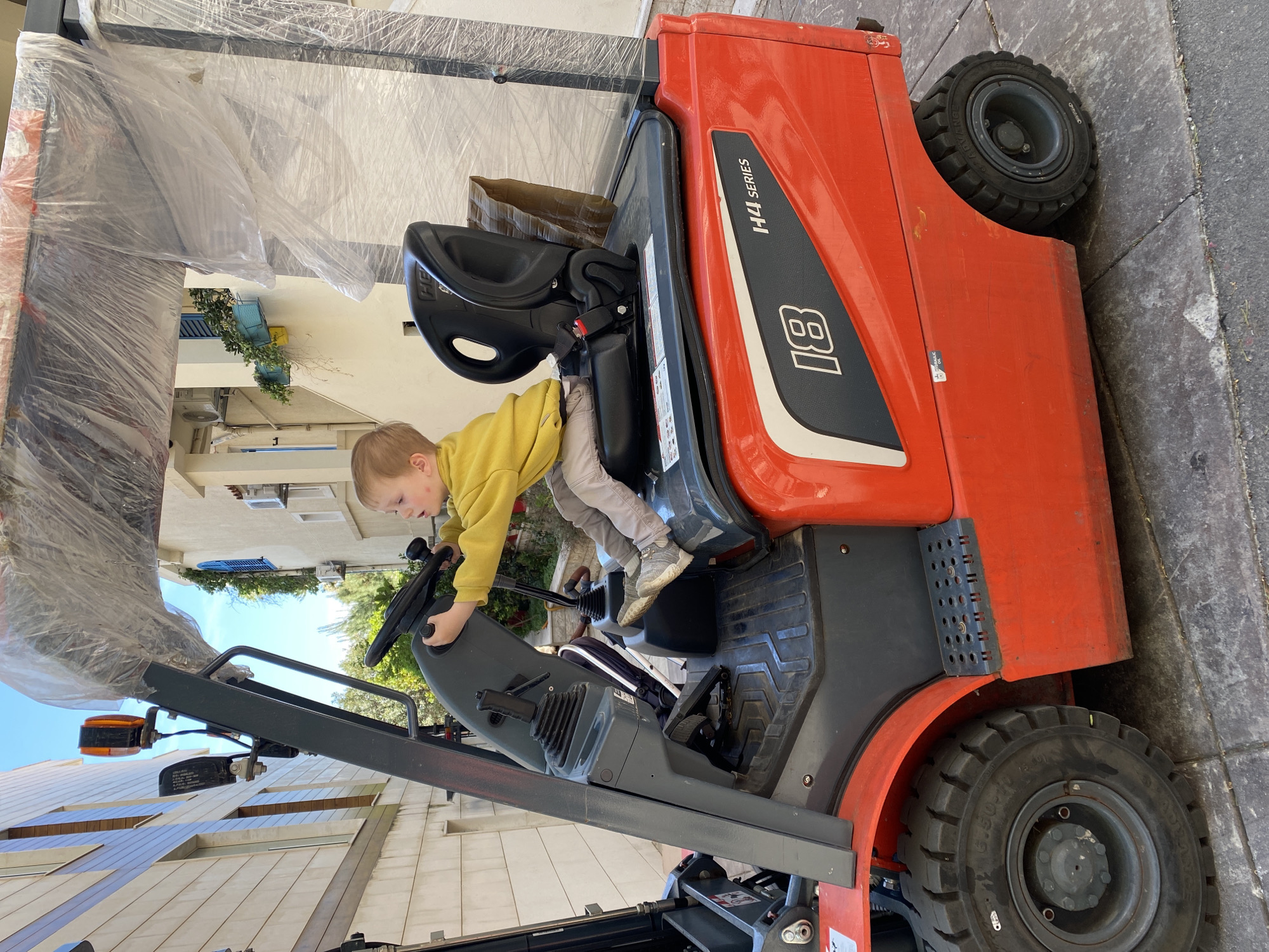 Child plays on parked forklift in Montenegro coastal town