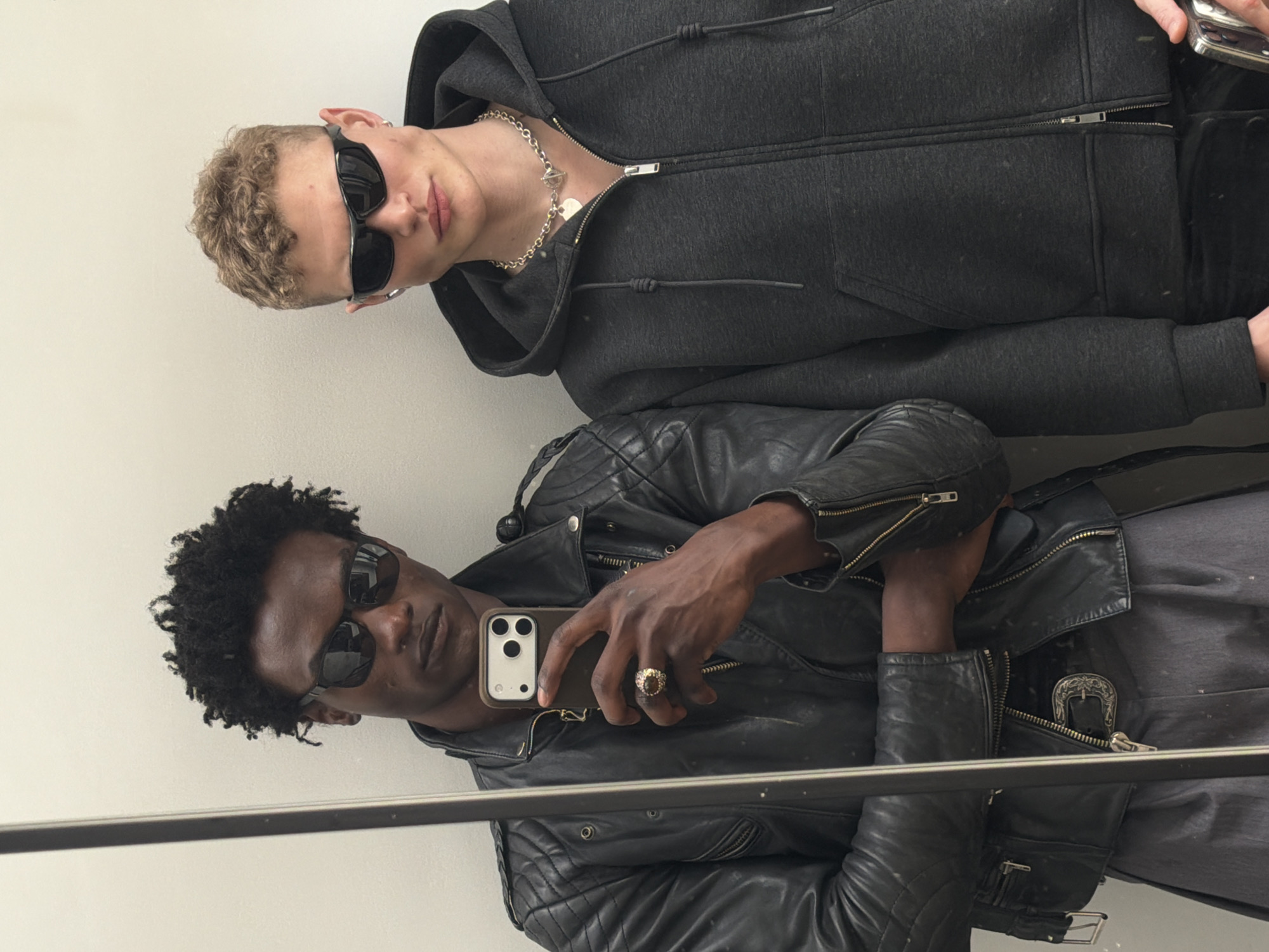 Two men captured in mirror reflection in London