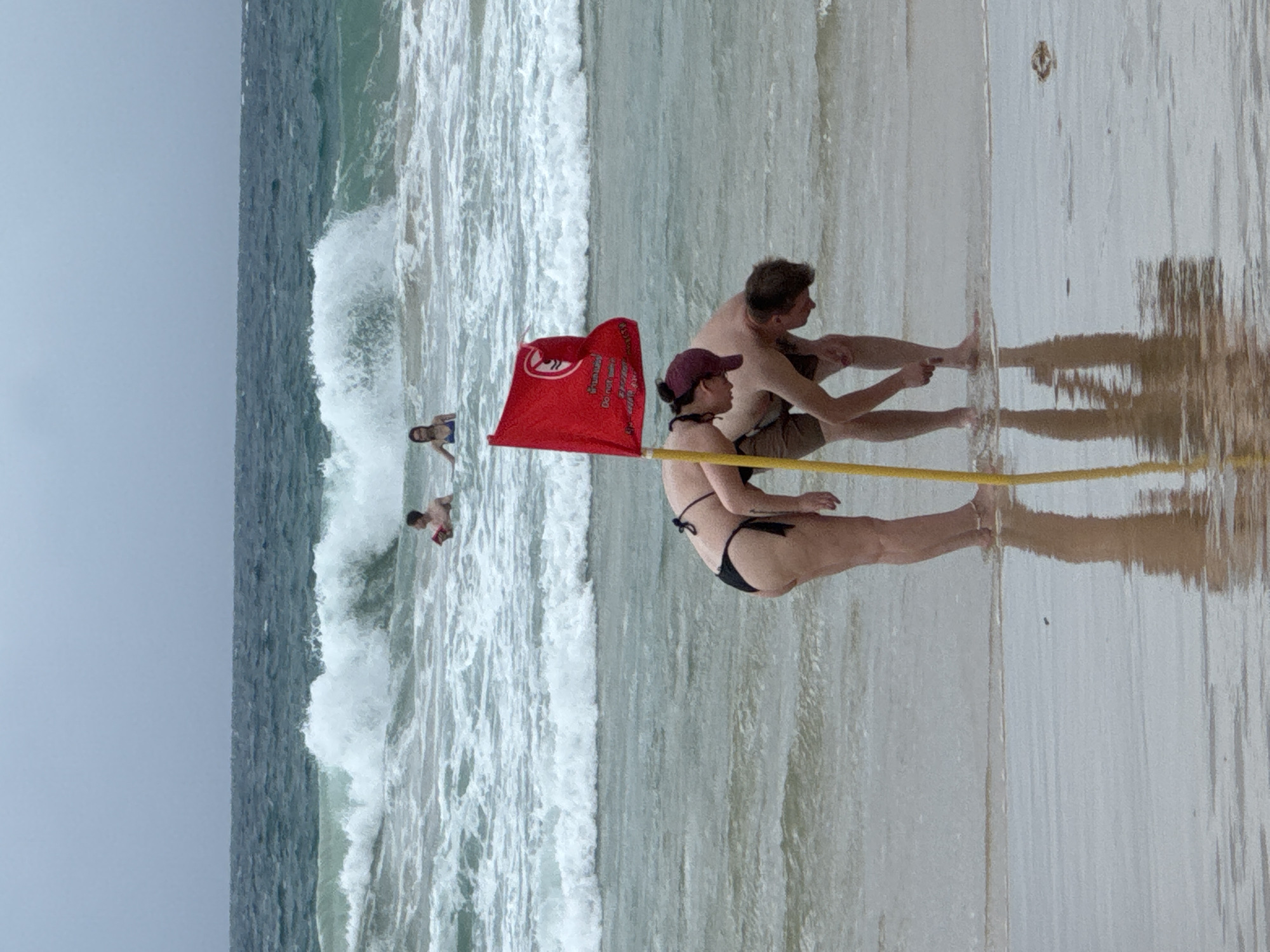 Karon Beach under warning flags, streets busy nearby
