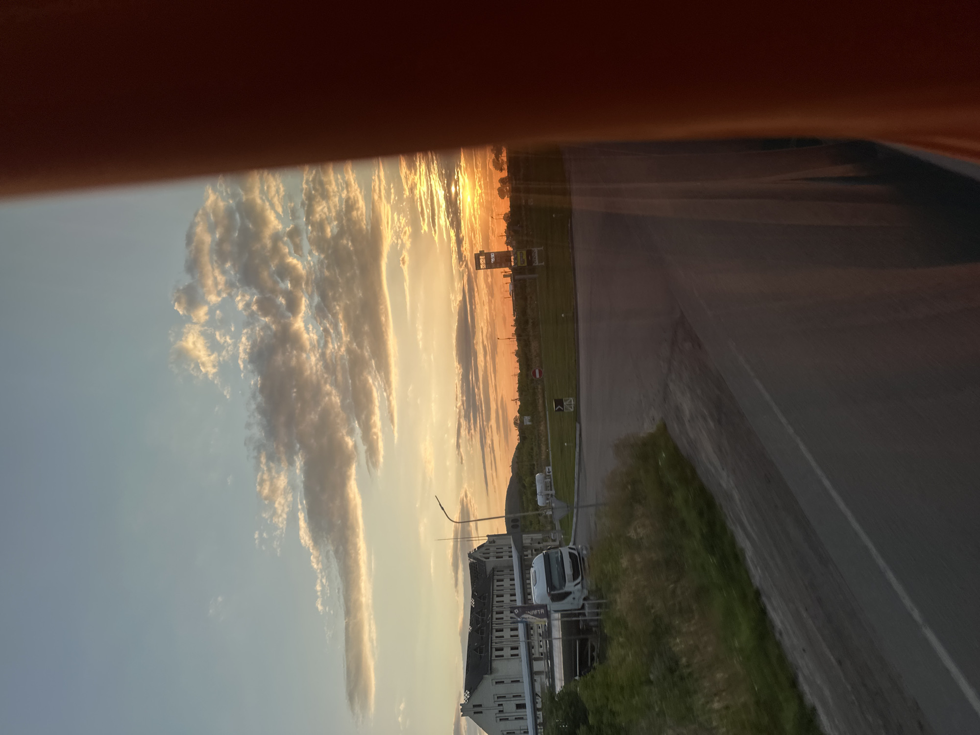 Warm sunset clouds over a curving road in Zolochiv, Ukraine
