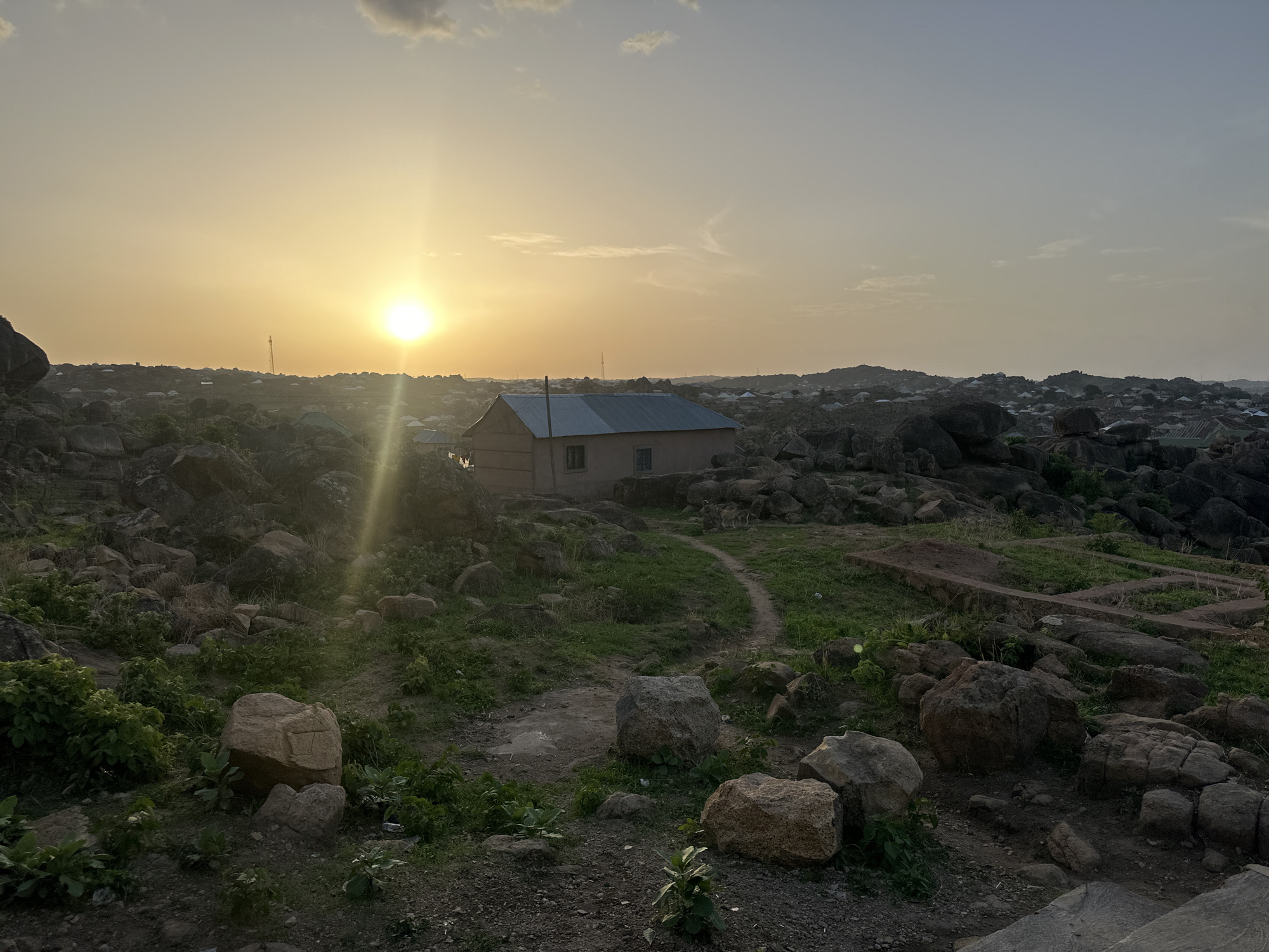 Sunset documented across Jos Nigeria's rocky landscape and neighborhoods