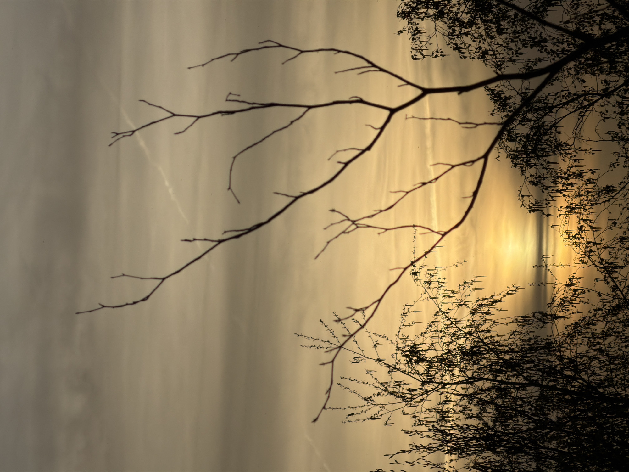 Hazy sunset observed through clouds in Schifflange, Luxembourg