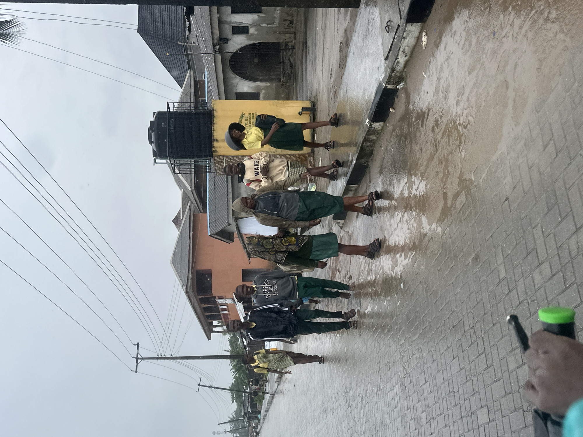 Students navigate flooded Badagry streets after school in the rain