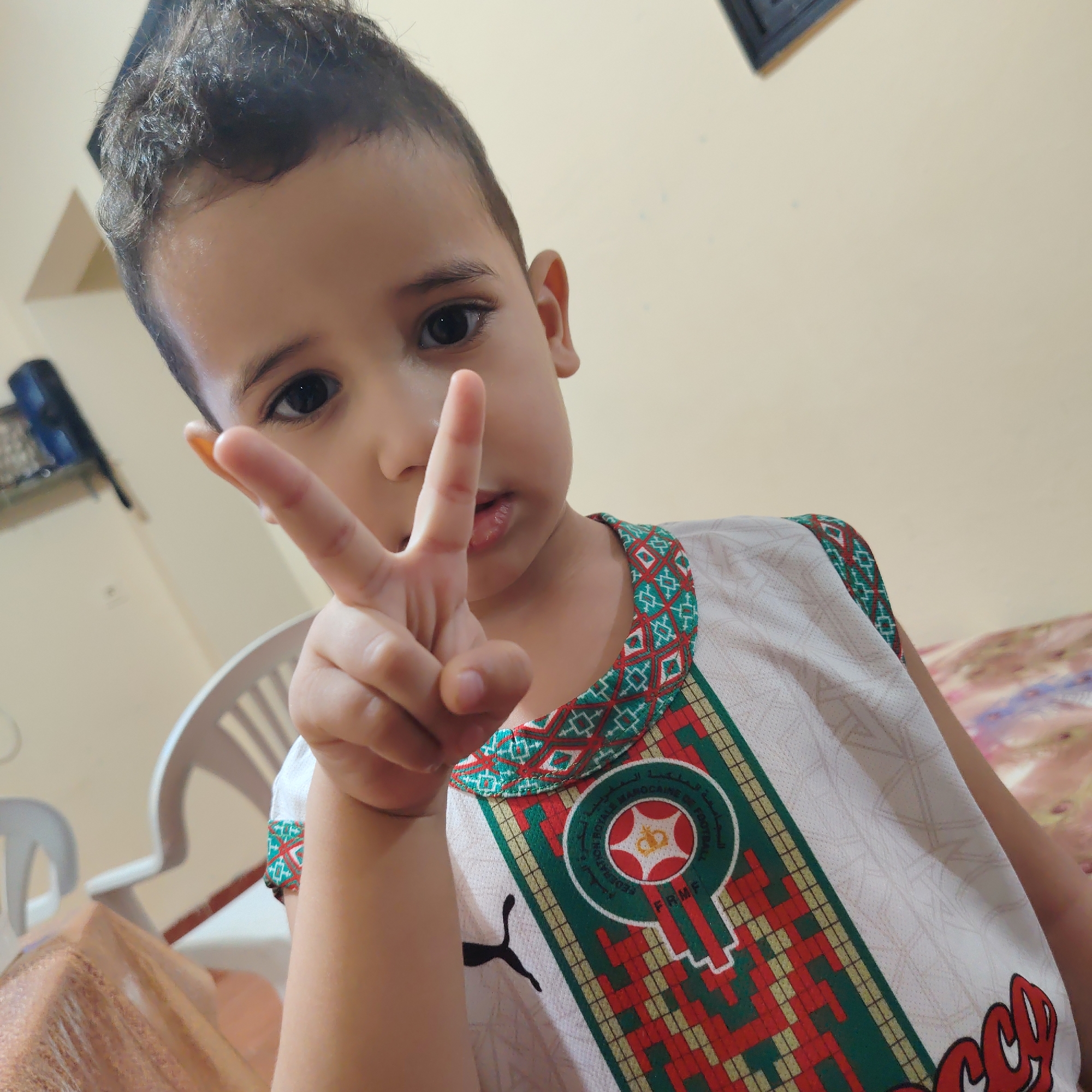 Kids in Ouaouizert show off Moroccan football kits indoors