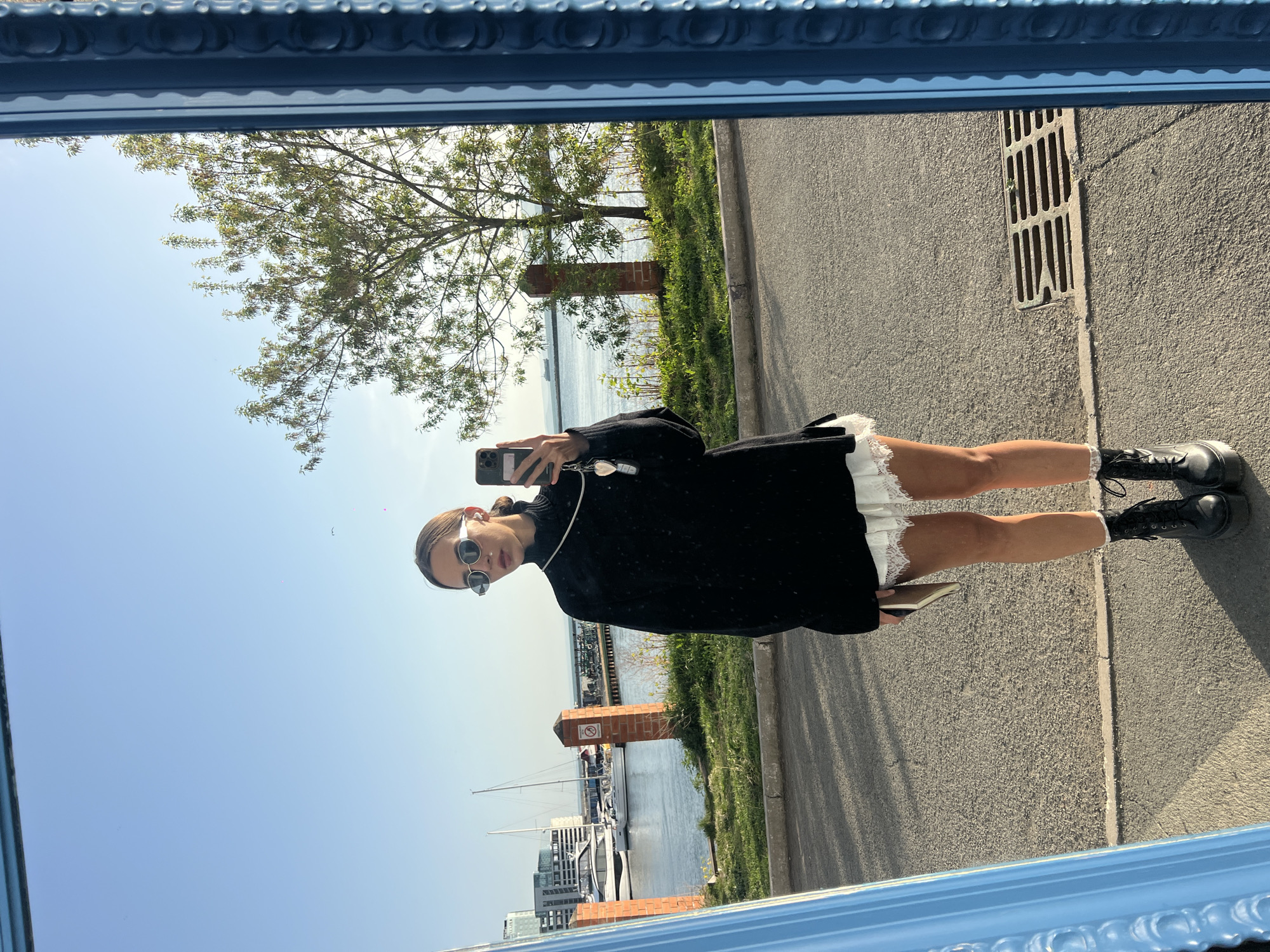 Woman takes mirror selfie overlooking Vladivostok harbor