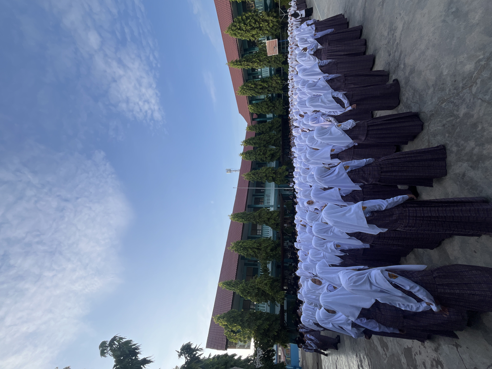 Students in formation outside a Lhokseumawe school, mid-morning.