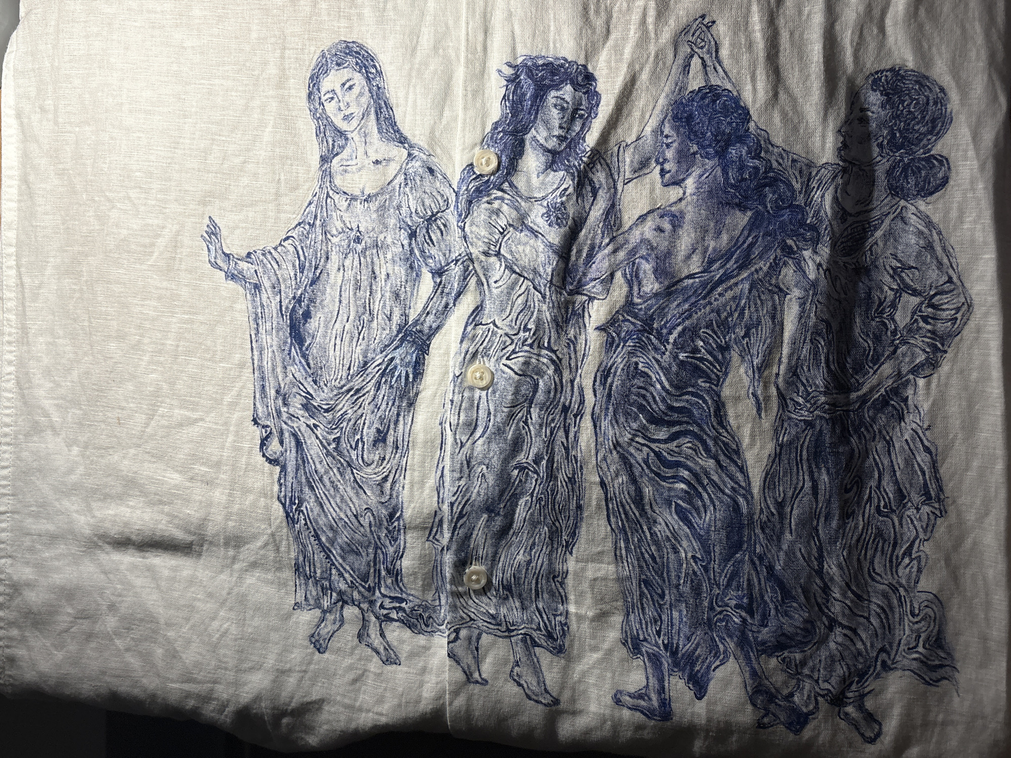 Blue-ink female figures artwork spotted on fabric garment Manchester